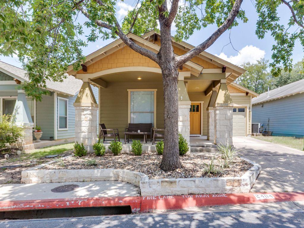 A welcoming front porch features stone-accented c