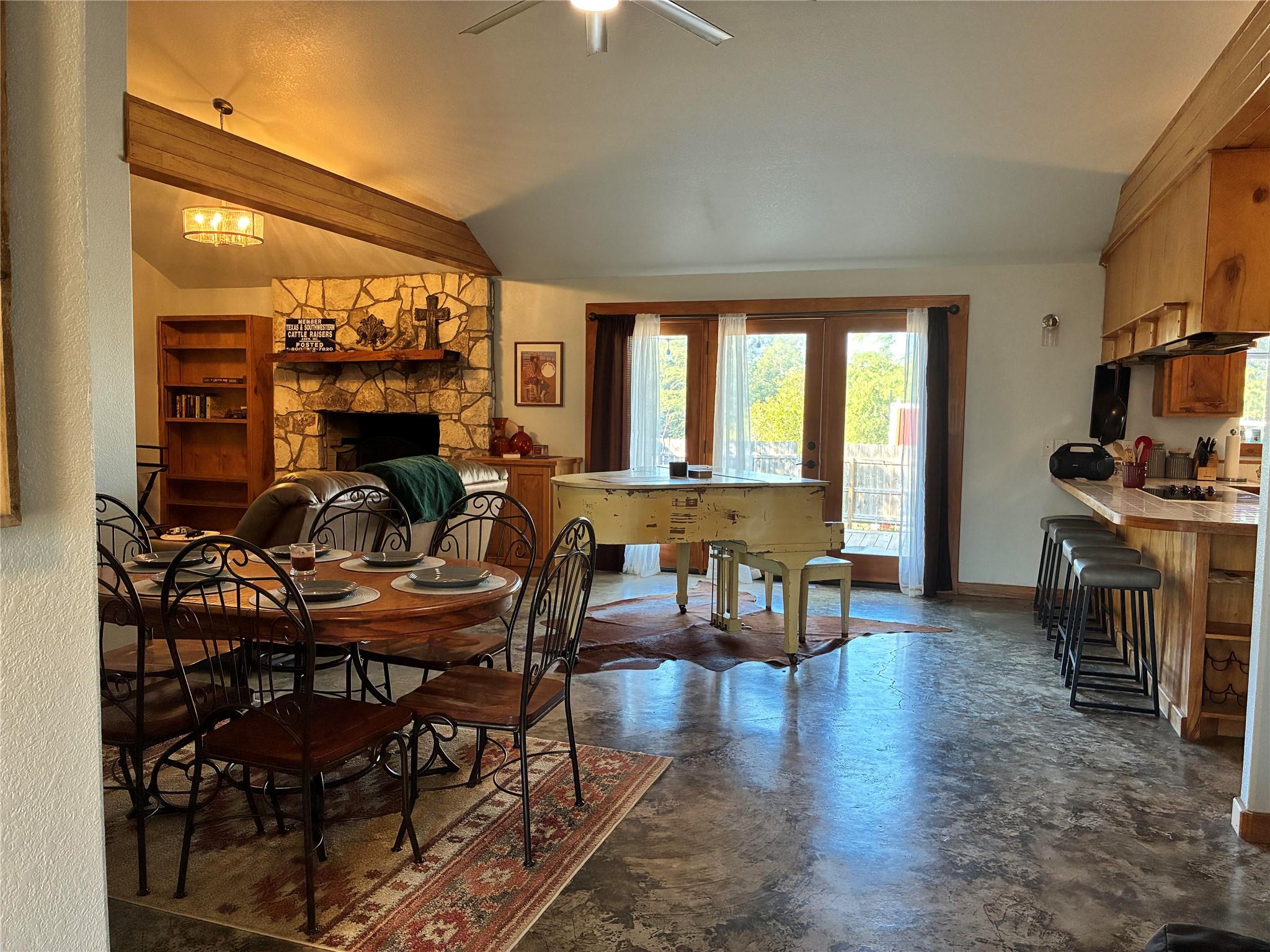 Polished concrete floors and a stone fireplace an