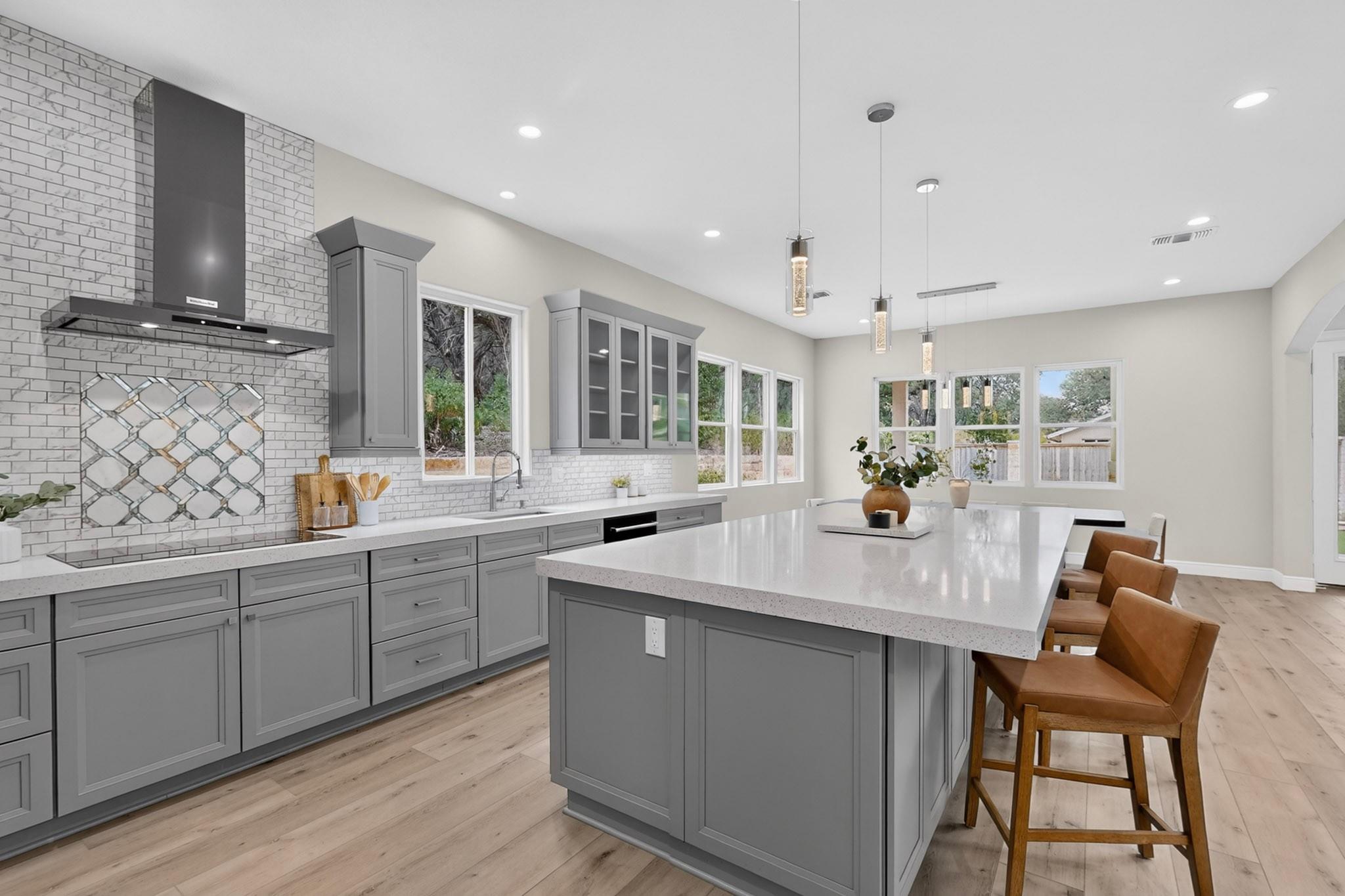 Sleek gray cabinetry and a large central island a
