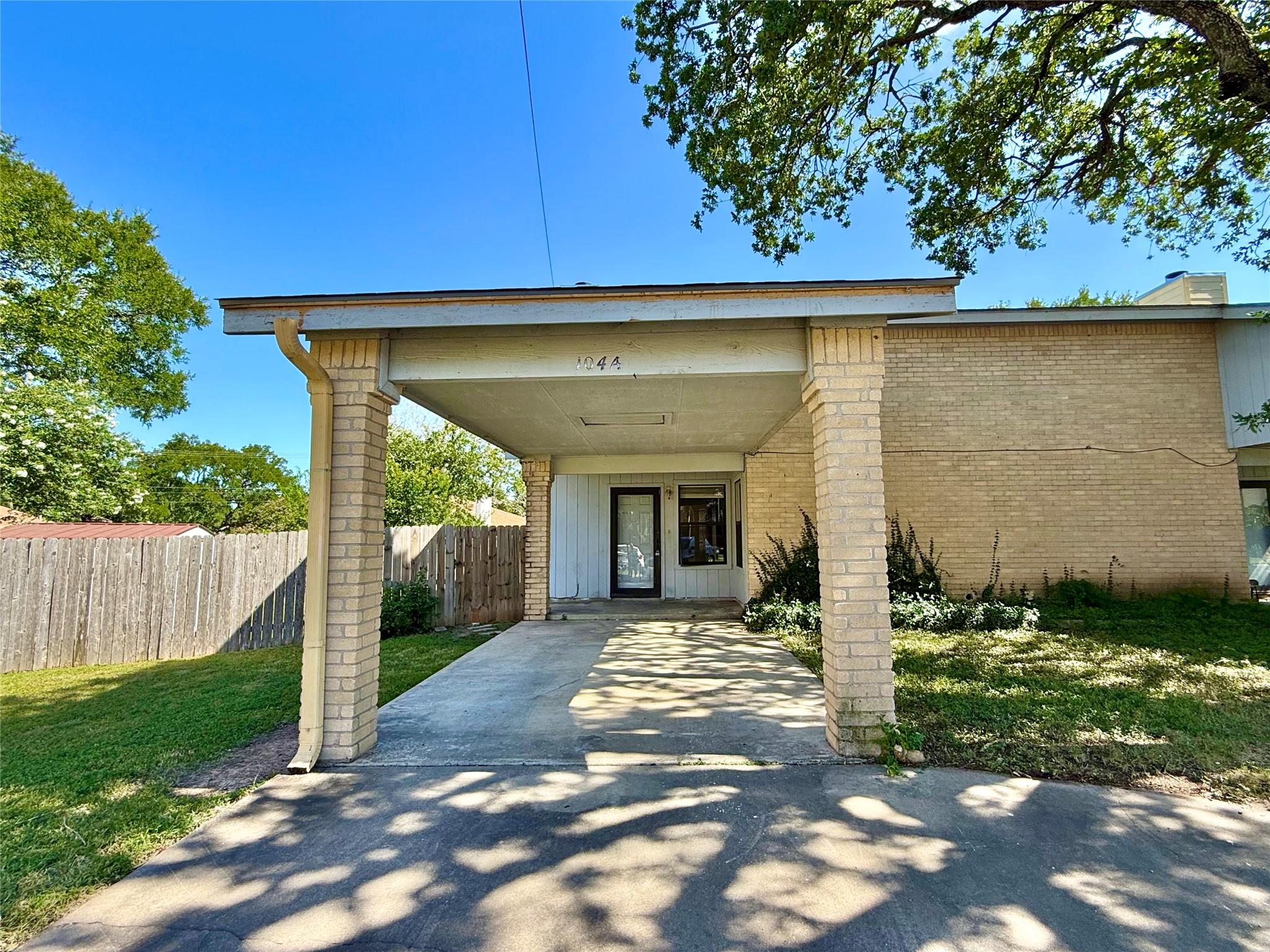 View of front of home with a carport, brick sidin