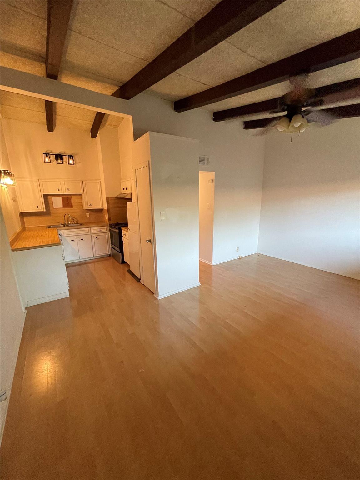 Rich wood beams accentuate the soaring ceilings o
