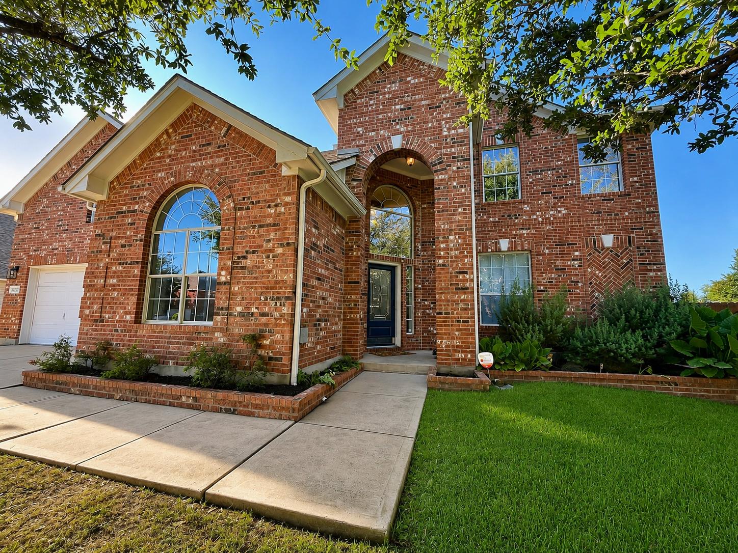 An arched entry and multi-paned windows highlight