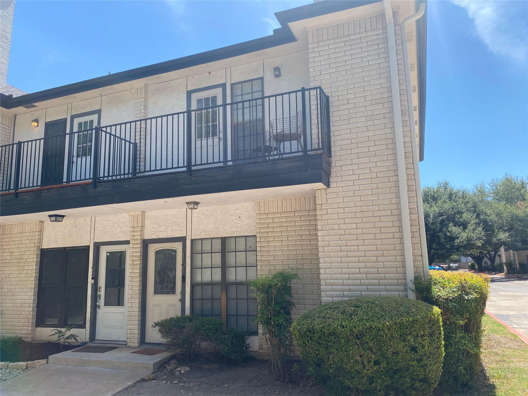 Brick veneer and stucco accents define the multi-