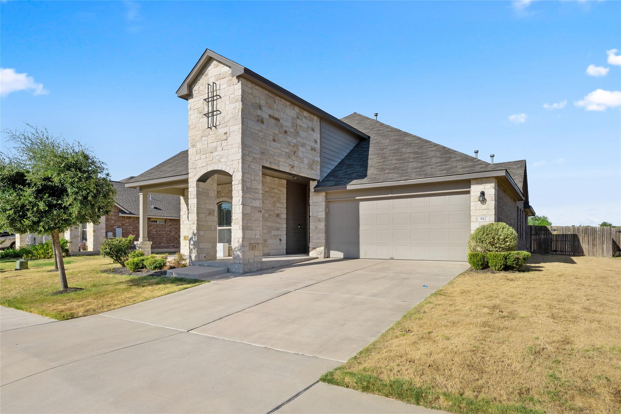 Textured stone veneer accents the entry facade al
