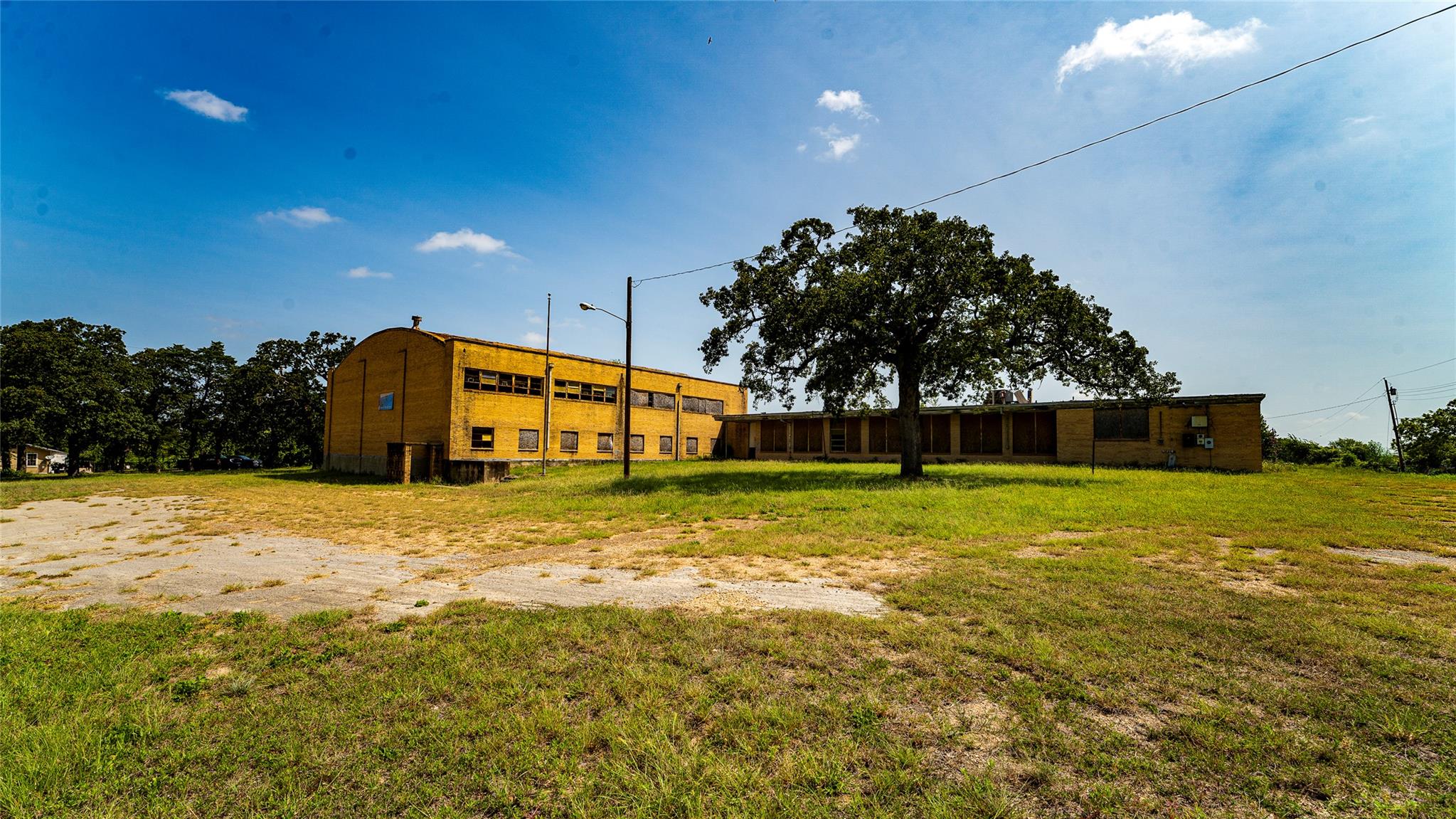 An expansive grassy lot surrounds this commercial