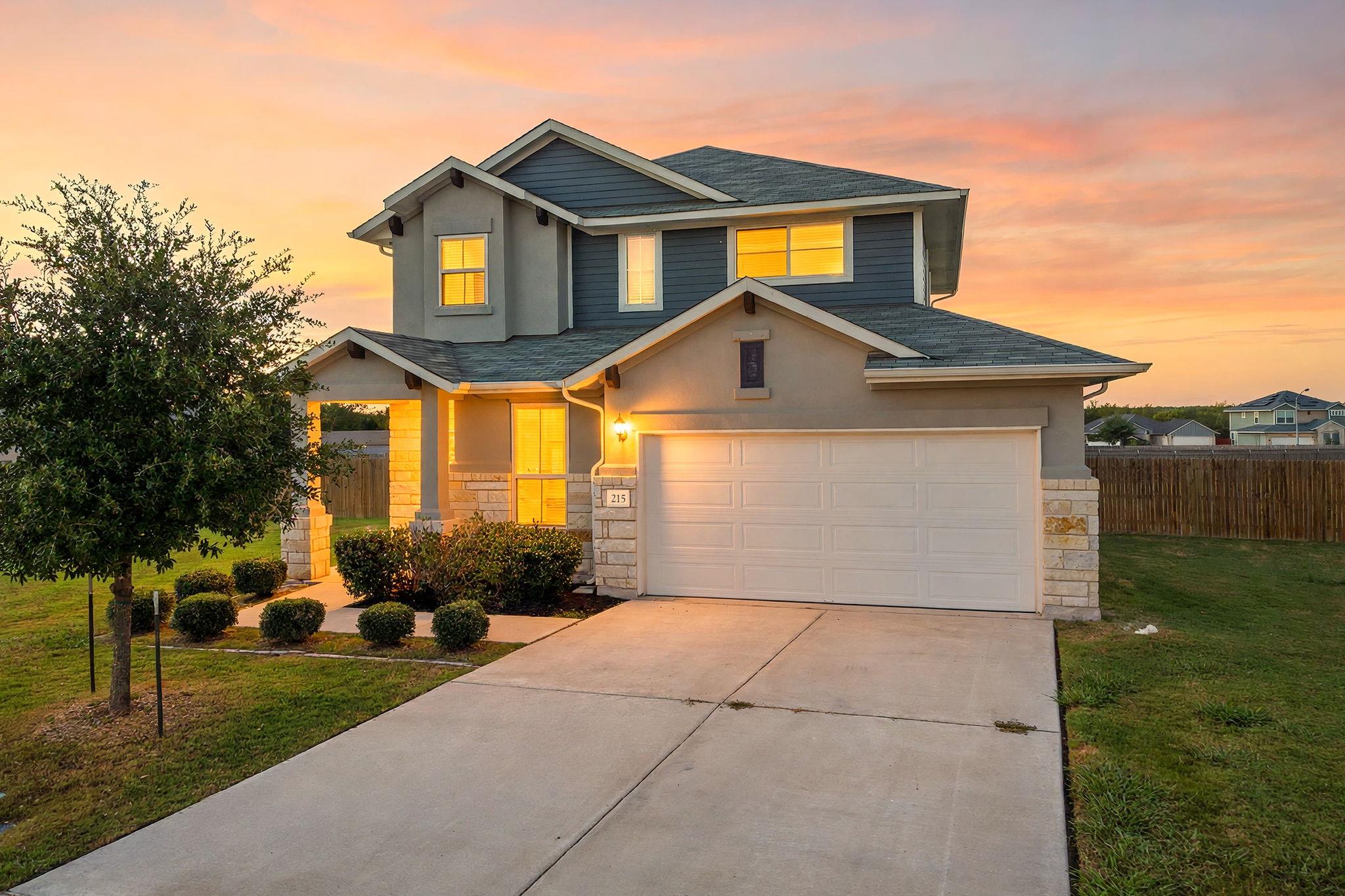 Warm exterior lighting accents this modern two-st