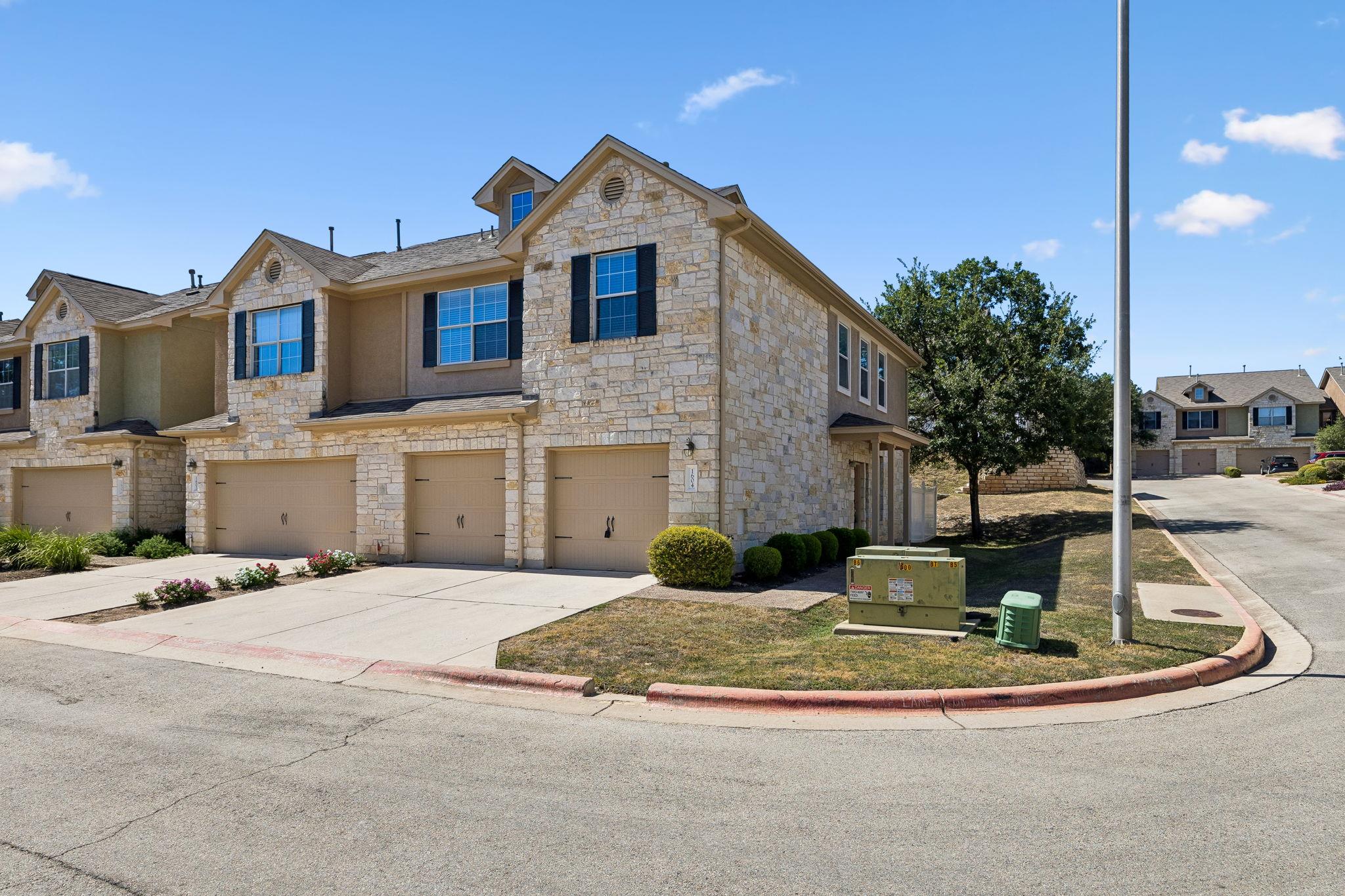 Stone accents and multiple garage bays define the