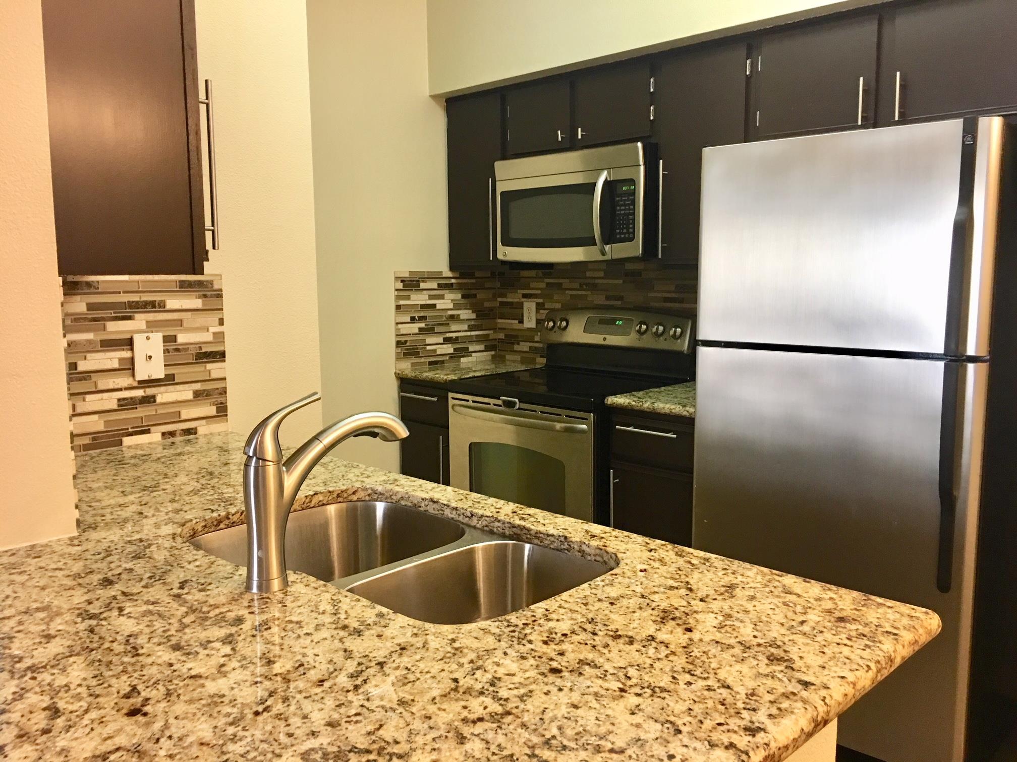 Polished granite countertops complement dark wood