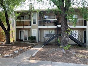 Mature trees shade a classic two-story exterior f