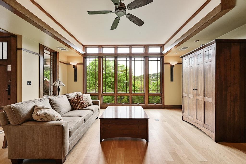 Rich wood trim and towering windows overlook lush