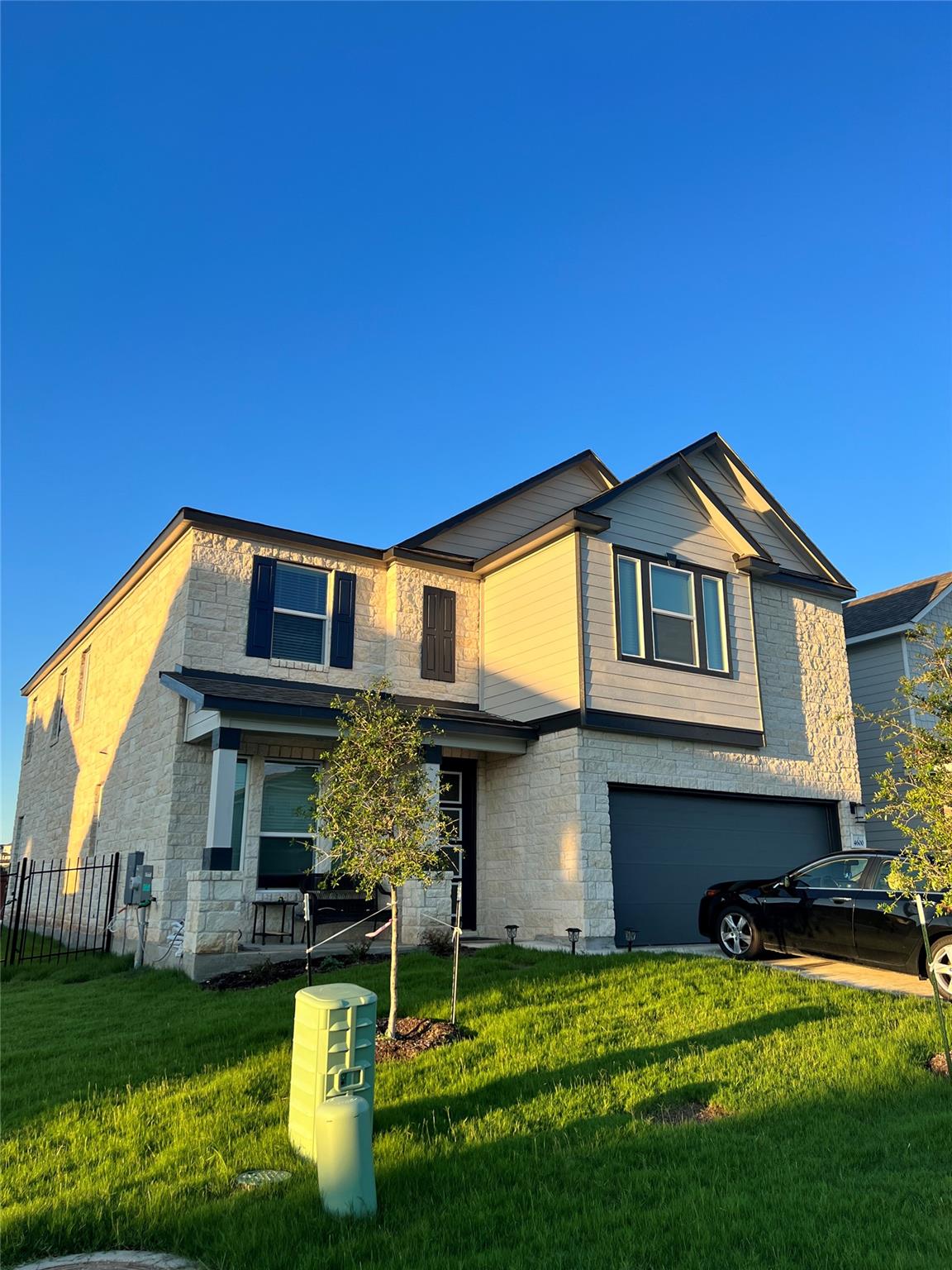 A classic two-story stone and siding facade stand