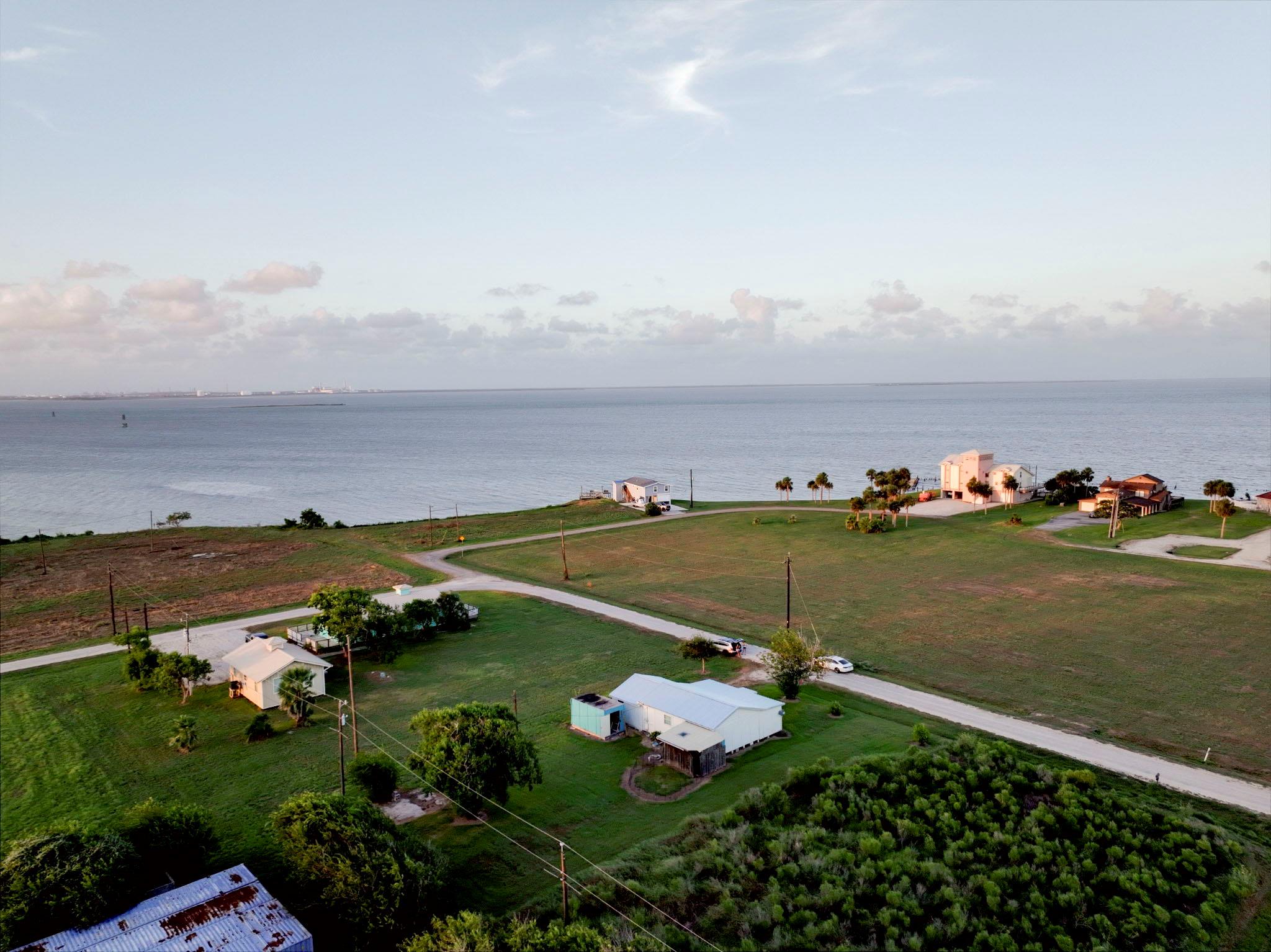 Aerial view showcasing open green spaces borderin