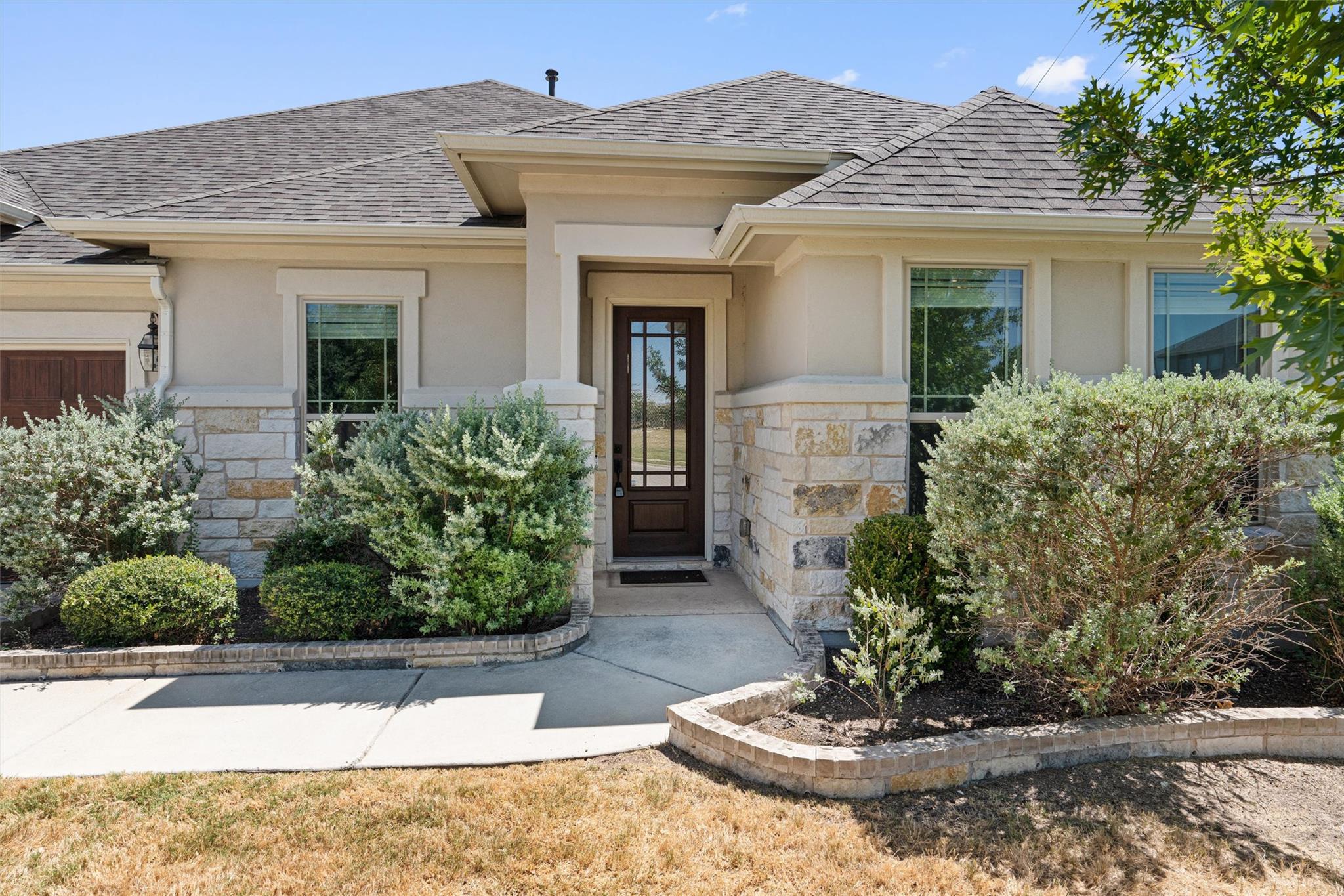 A welcoming front entrance features structured st