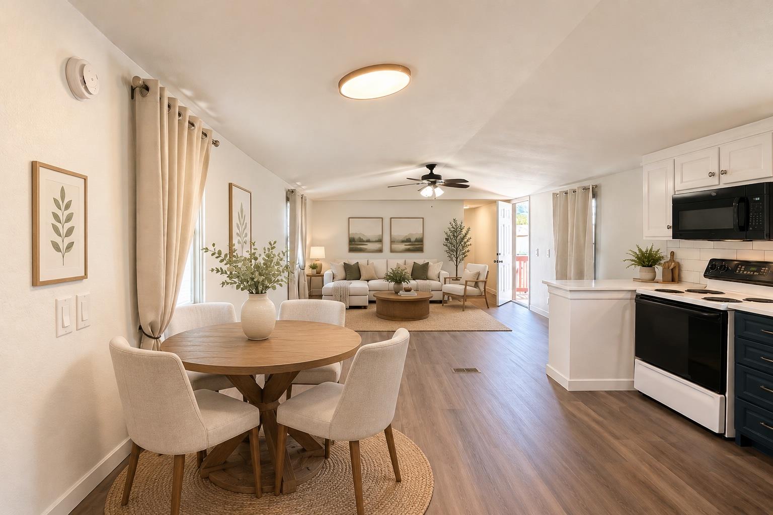 Warm wood flooring connects the comfortable dinin