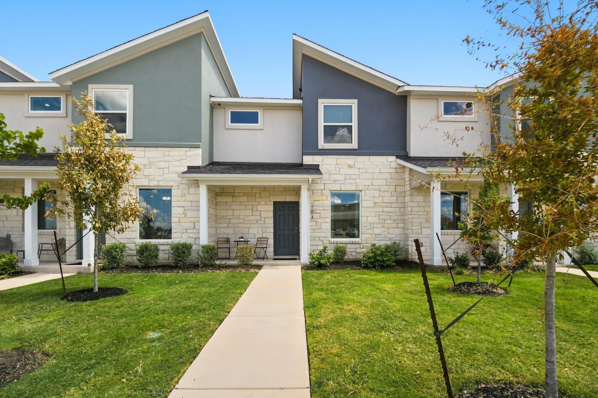 Angled rooflines and textured stone masonry defin