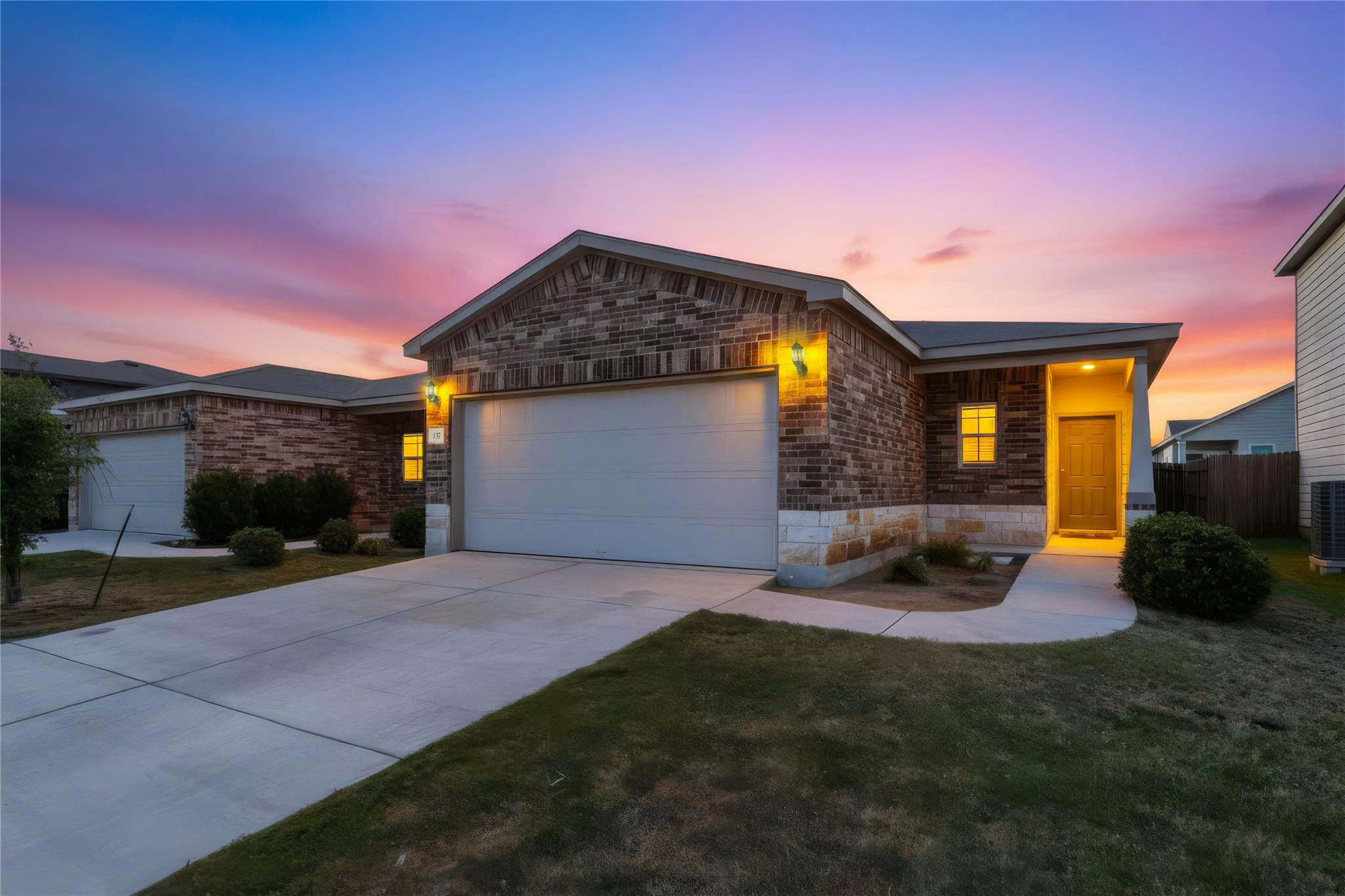 Textured brick masonry and a concrete driveway de