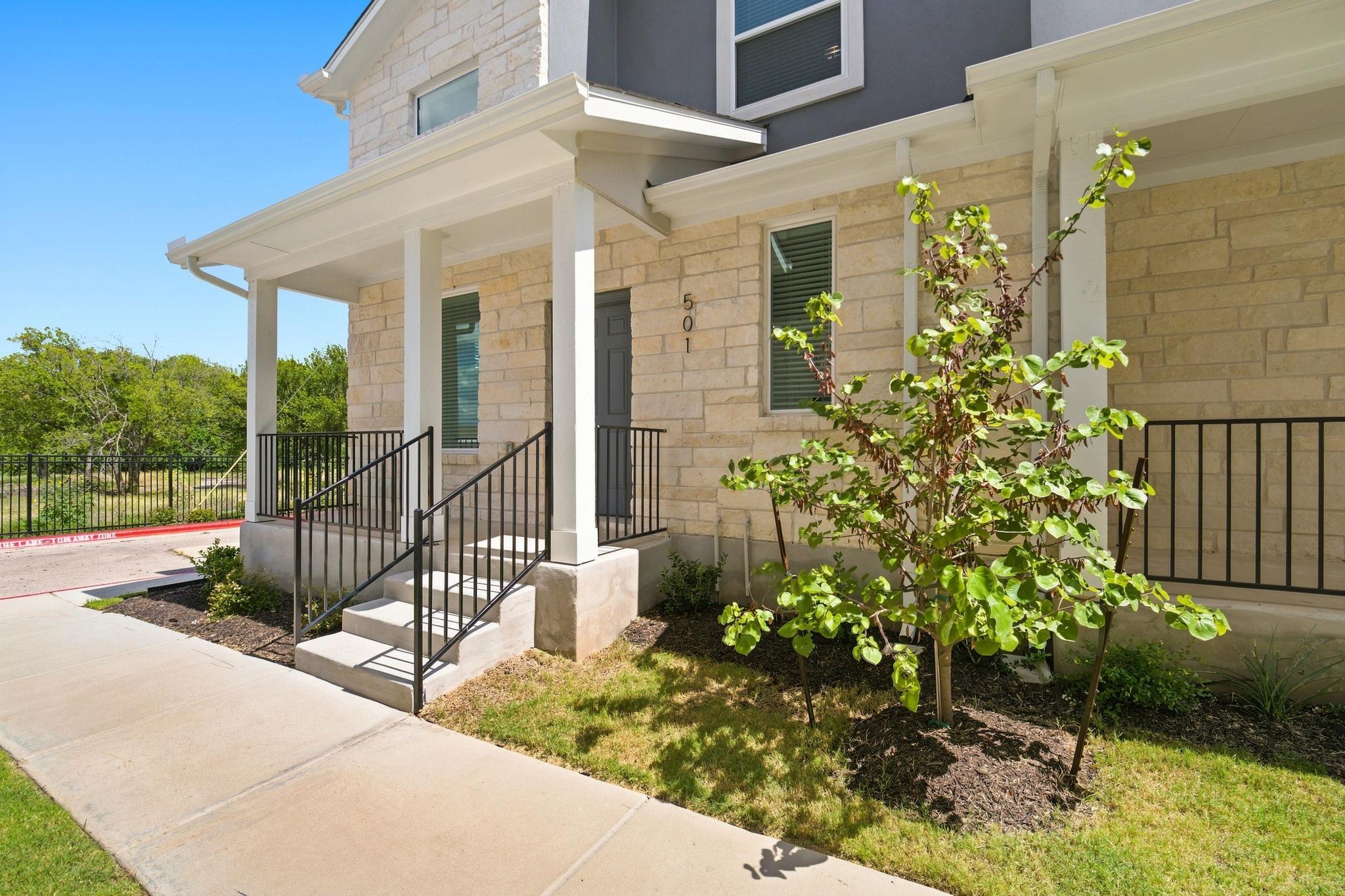 Stone masonry accents and a covered porch establi