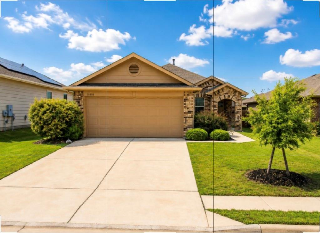 Neat landscaping frame the concrete driveway lead