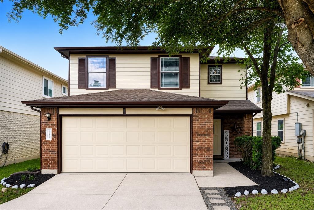 A classic two-story brick and siding facade featu