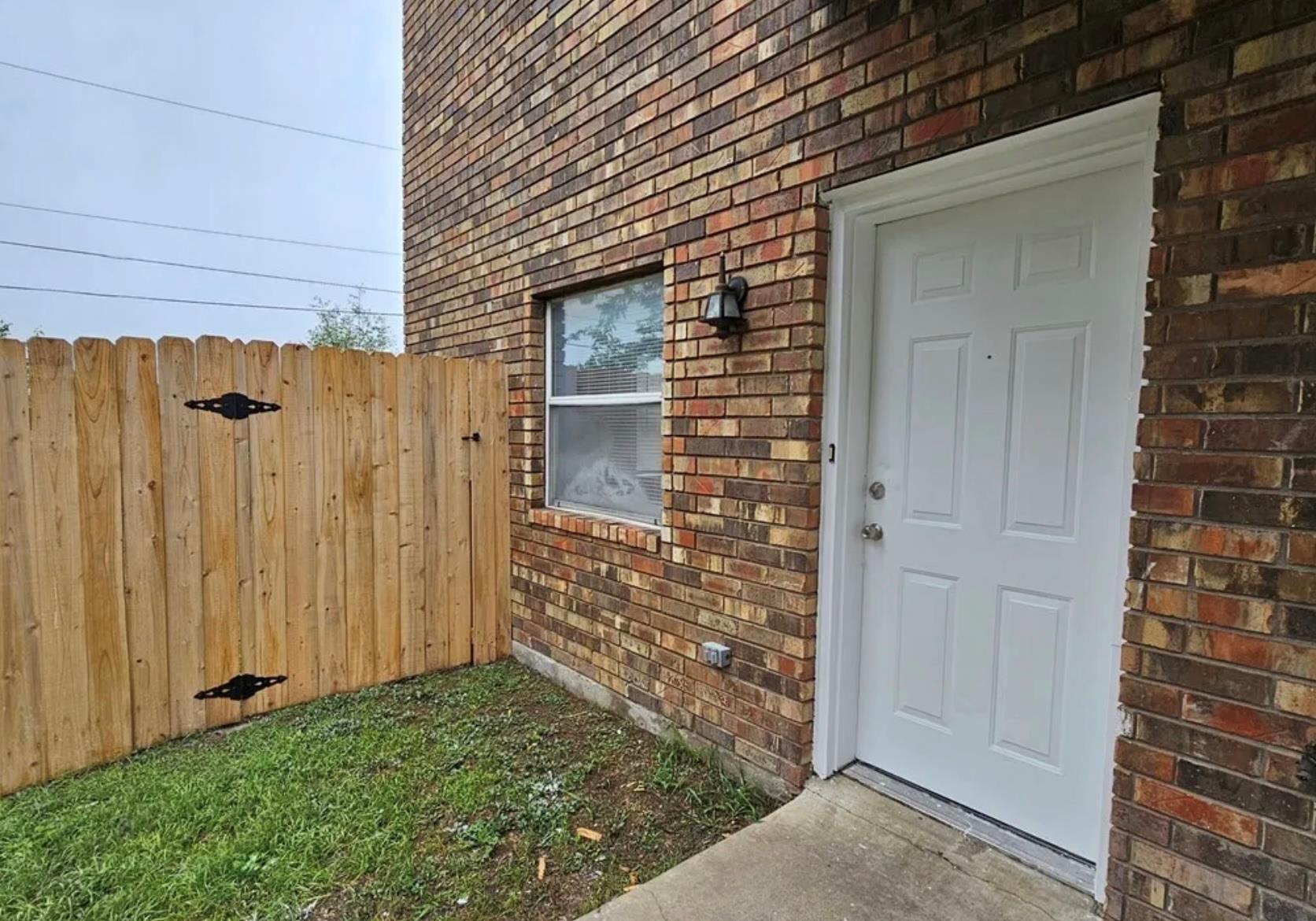 Multi-toned brick walls and a private entrance wi