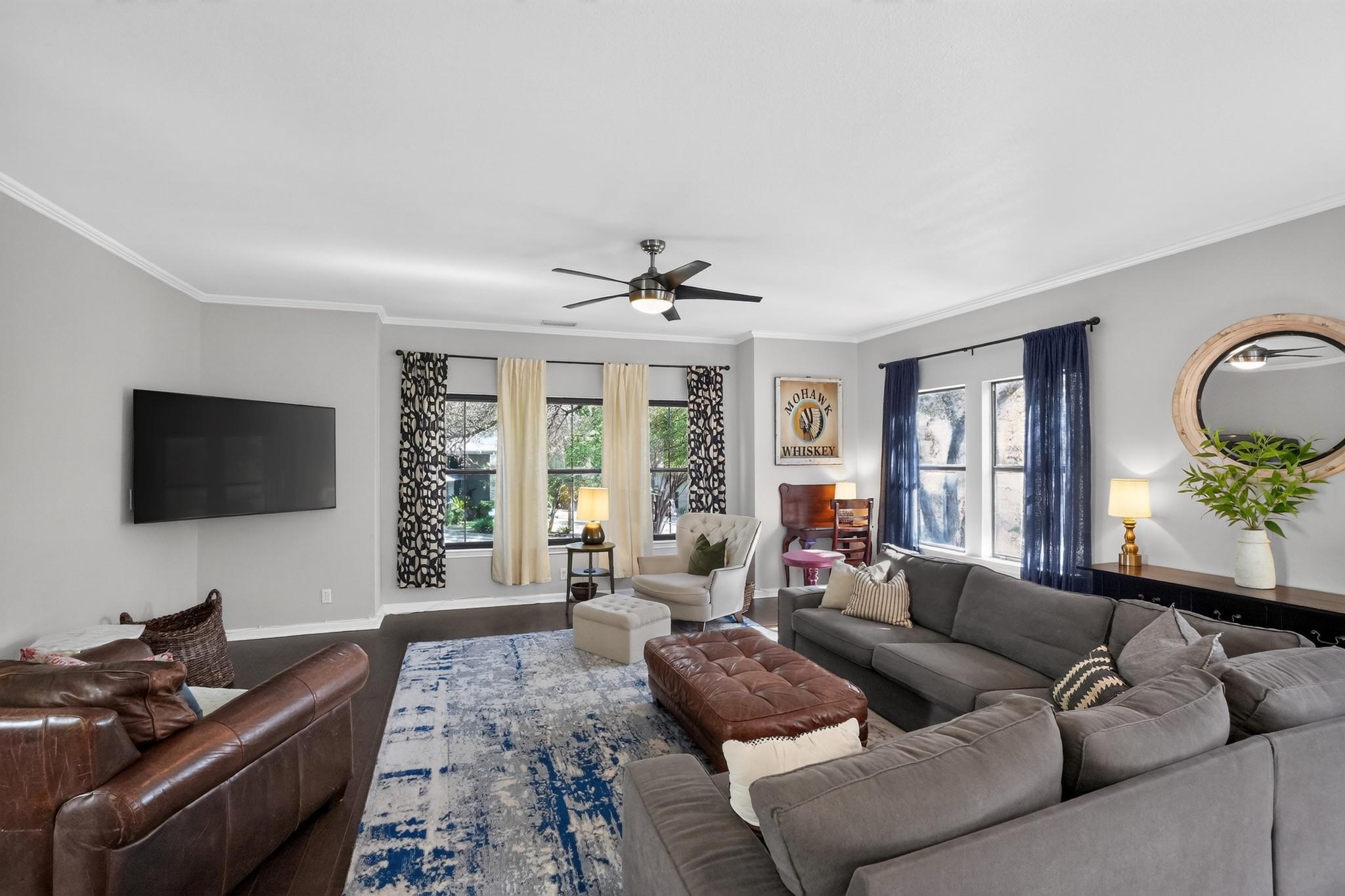 Rich wood flooring and elegant crown molding defi