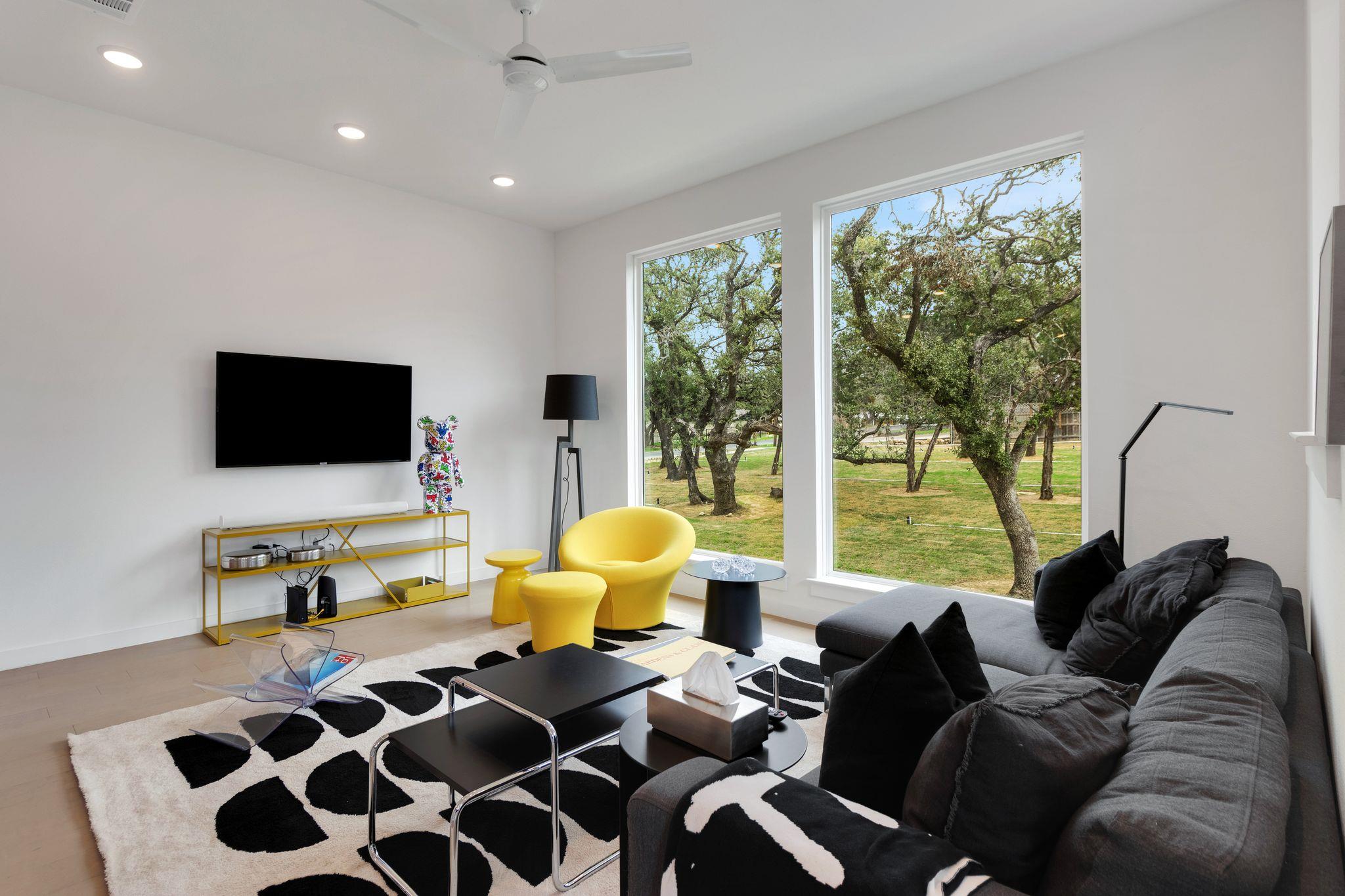 Floor-to-ceiling windows frame serene wooded view