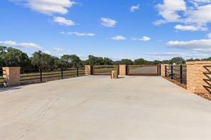 Secure gated entry welcomes visitors with a wide 