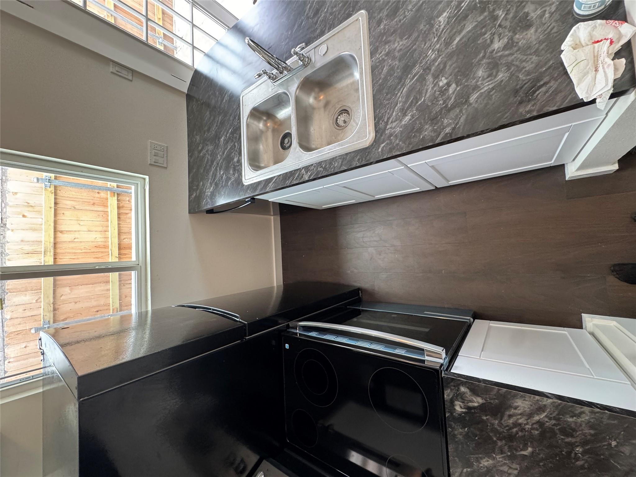 Streamlined kitchen workspace features deep stone