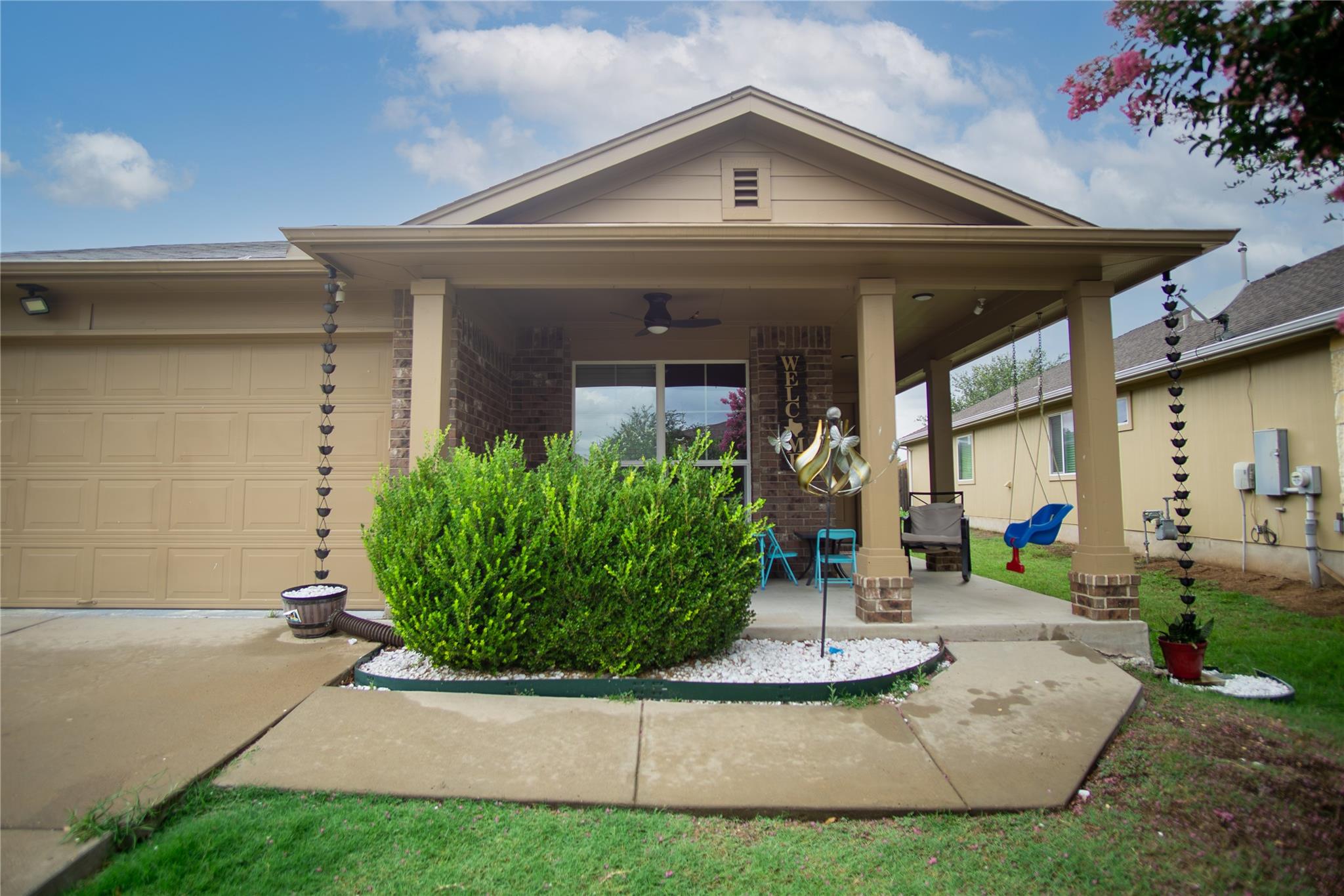 An inviting covered front porch with brick accent