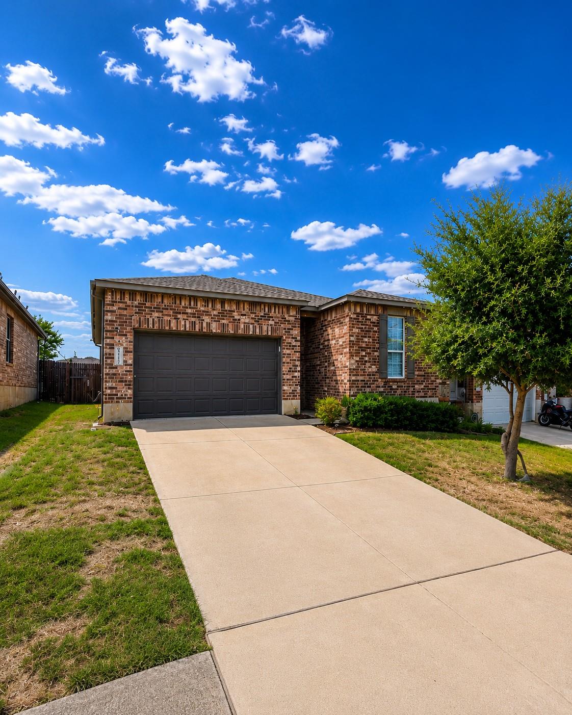 Brick exterior detailing and a concrete driveway 