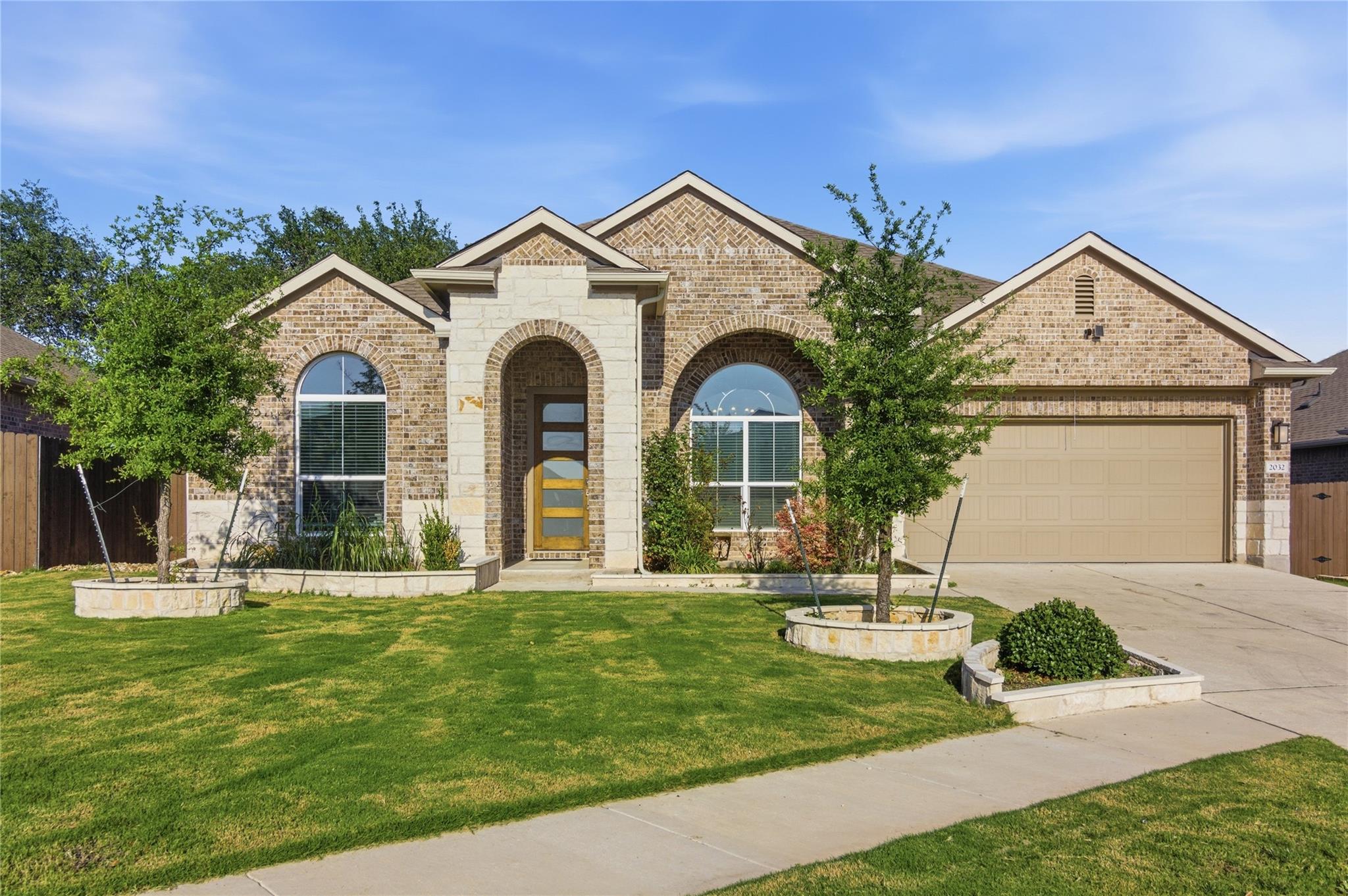 A classic brick exterior presents an arched entry