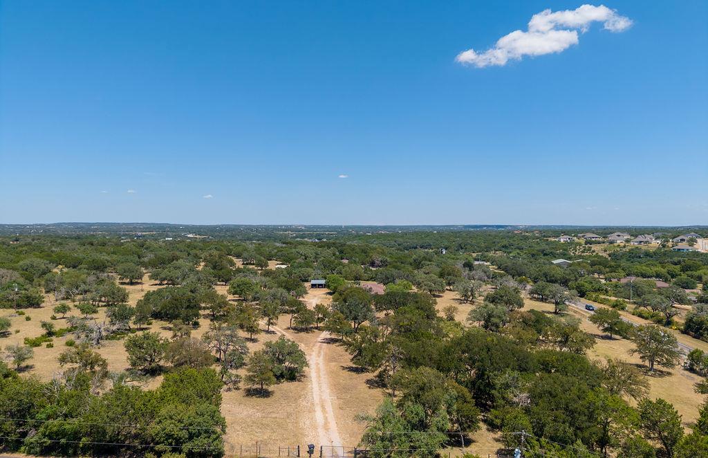 Mature trees and rolling terrain stretch across t