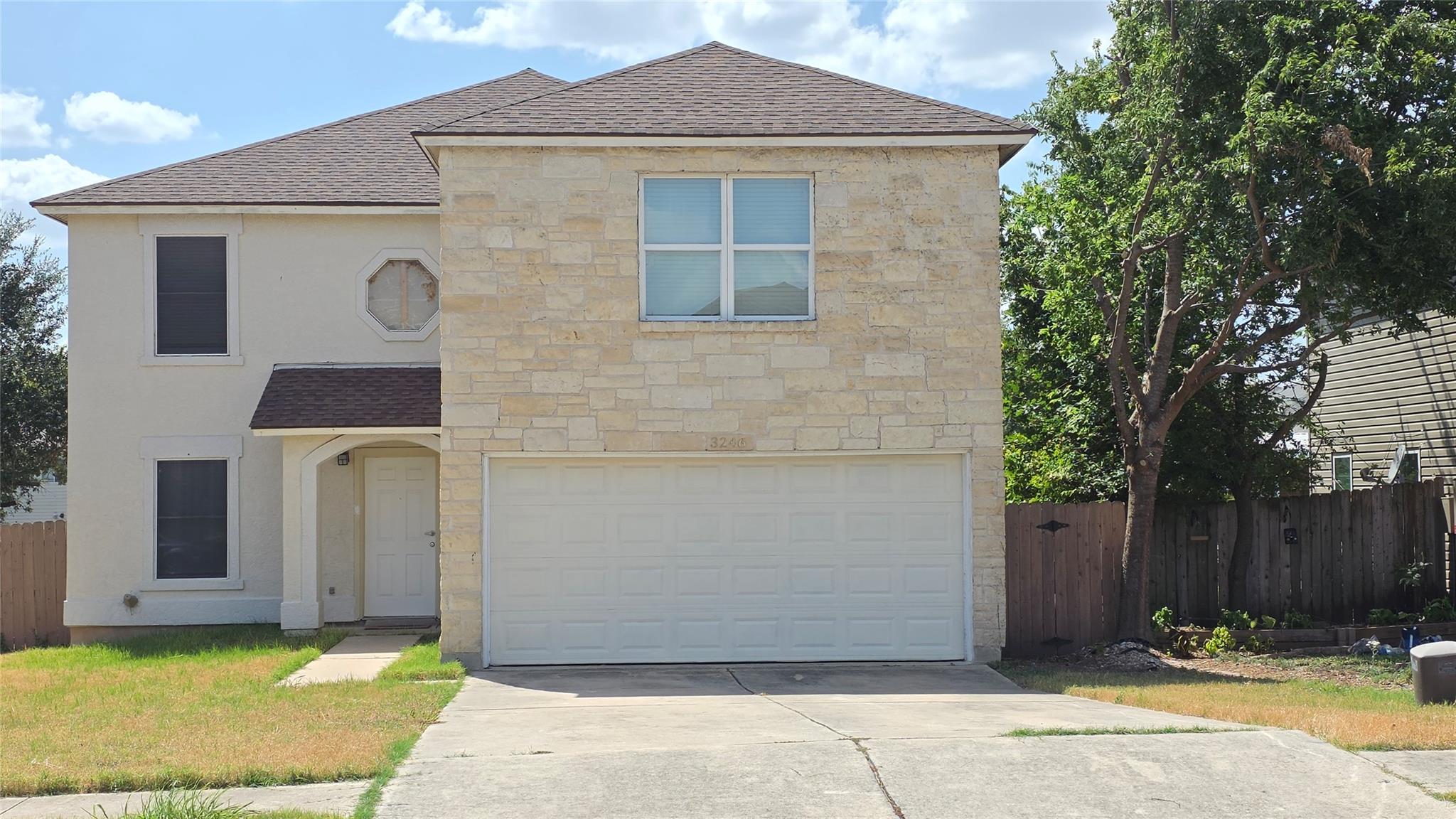 A classic stone and stucco exterior anchors this 