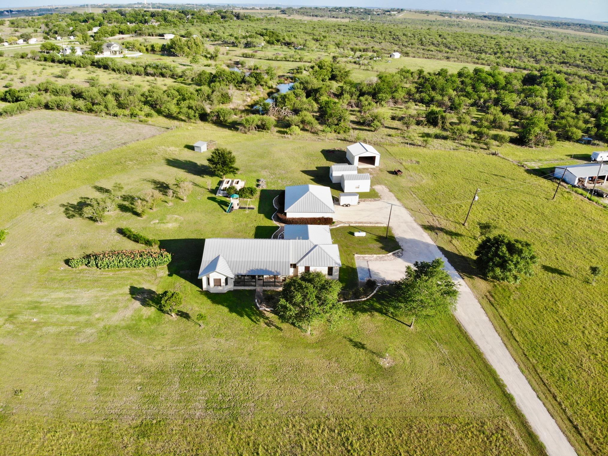 A metal roof tops this rural homestead surrounded