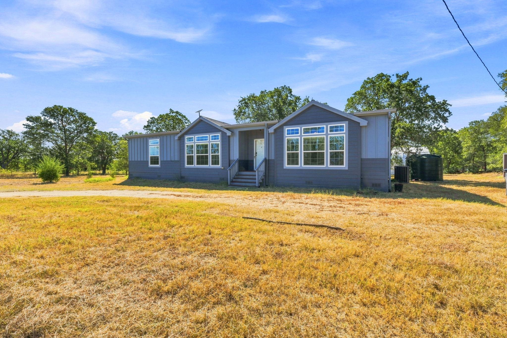 A classic ranch exterior showcases large multi-pa