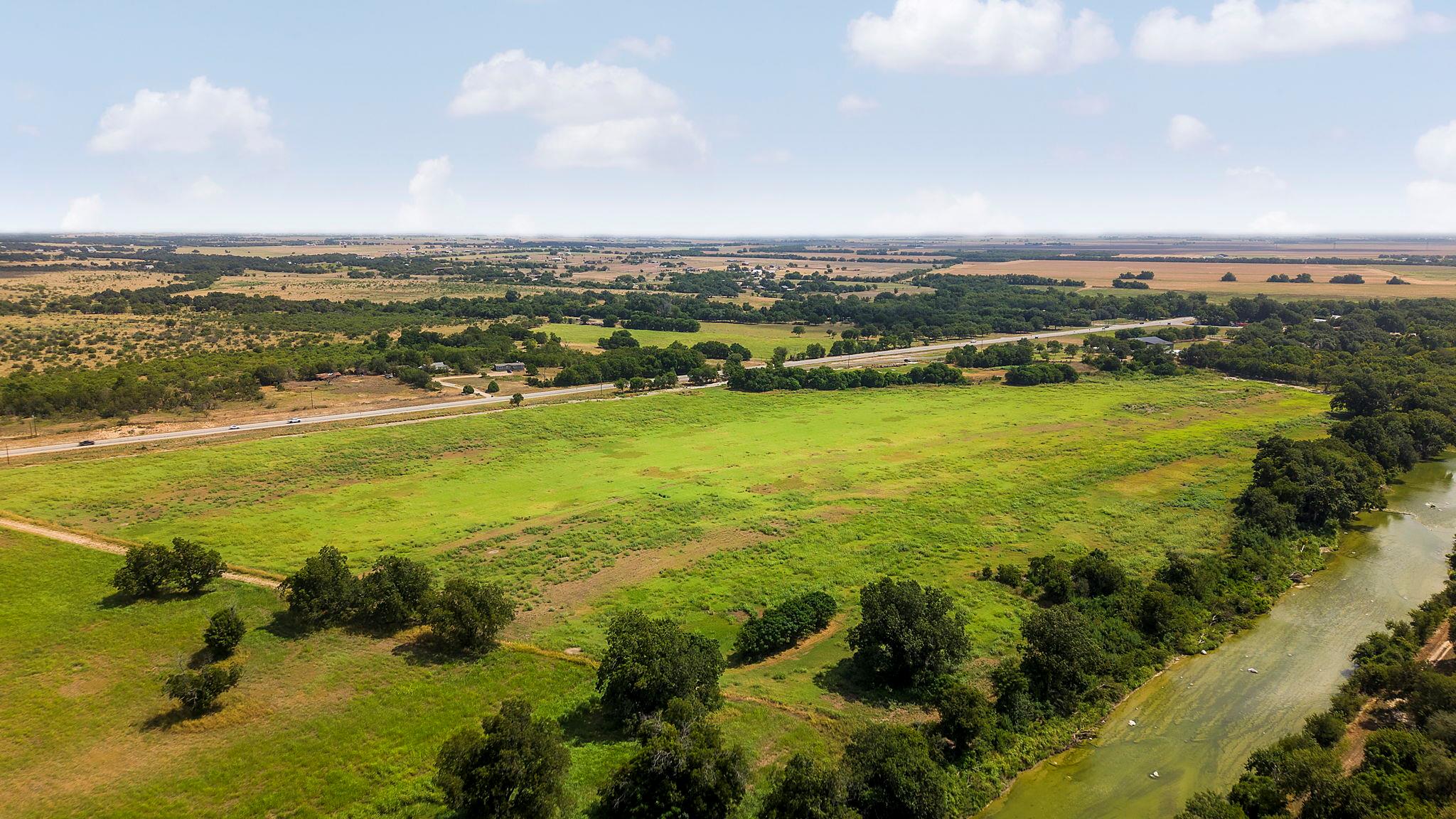 Mature trees line the peaceful river winding alon
