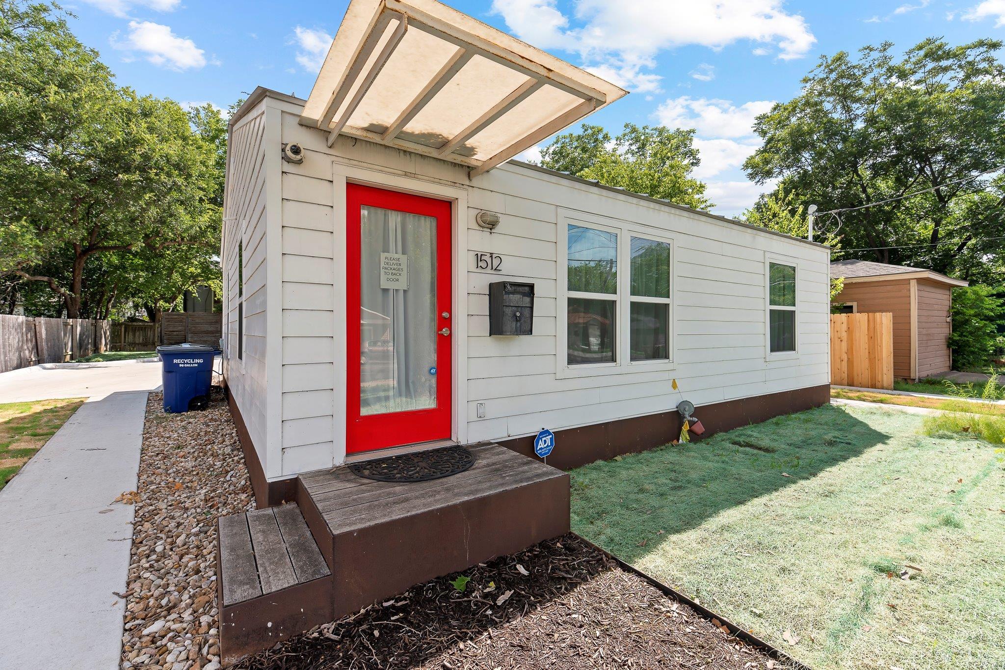 A vibrant entry door welcomes guests to this cozy