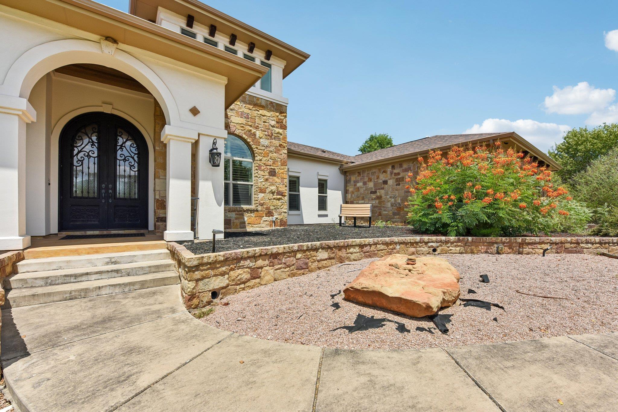 Arched entryways and stone accents create a comma