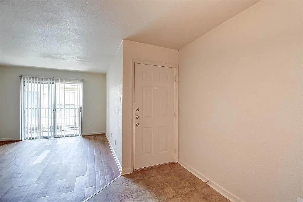 Tiled entryway leads directly into a living area 