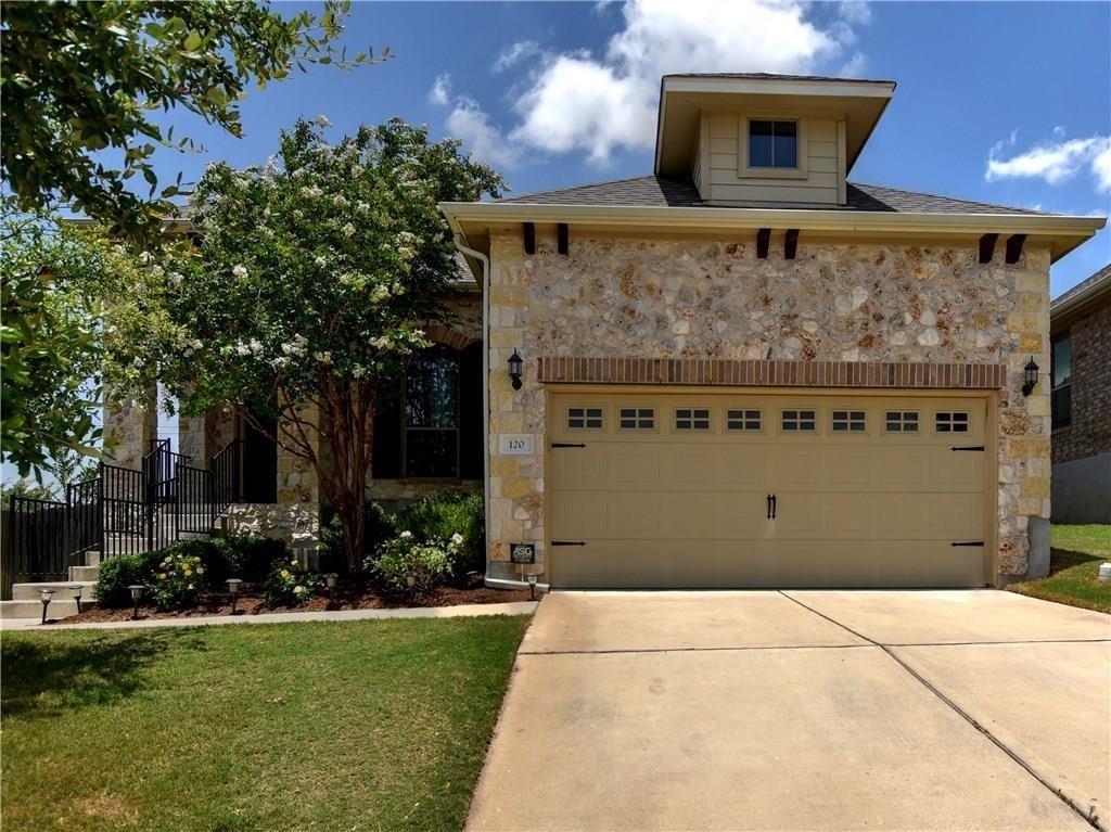 Natural stone masonry and a concrete driveway lea