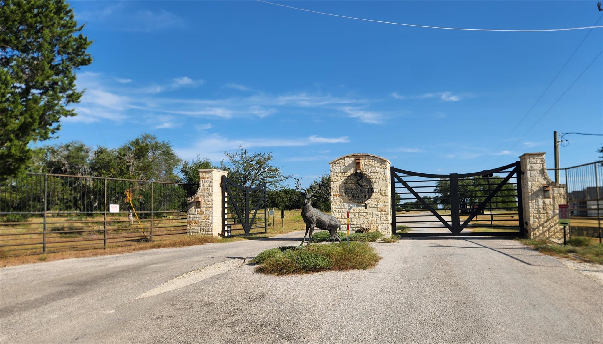 A secure gated entry features stone pillars and a
