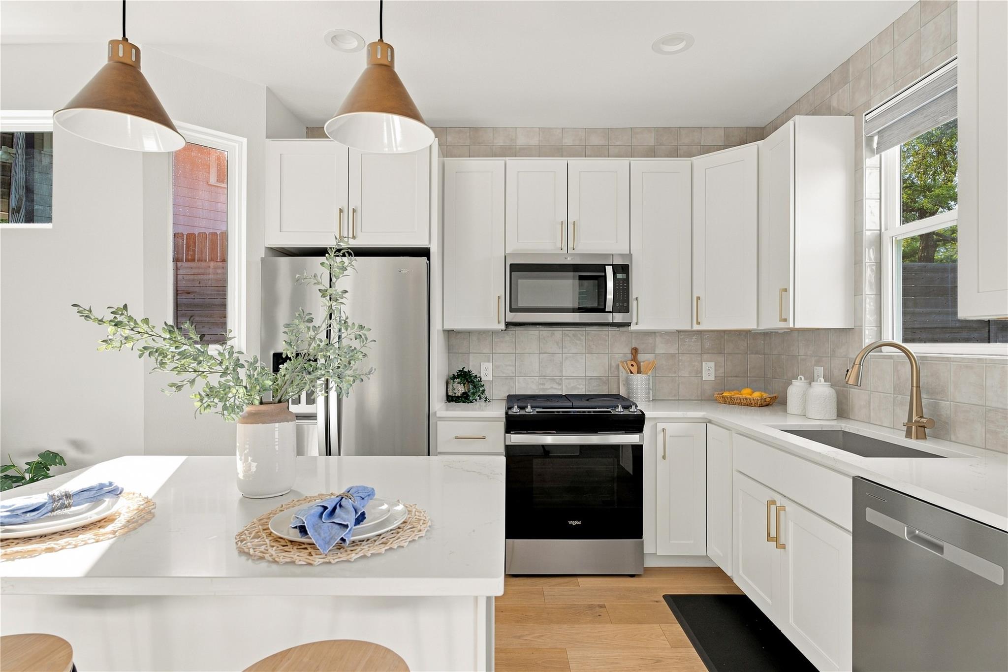 Gleaming stone countertops and stainless steel ap