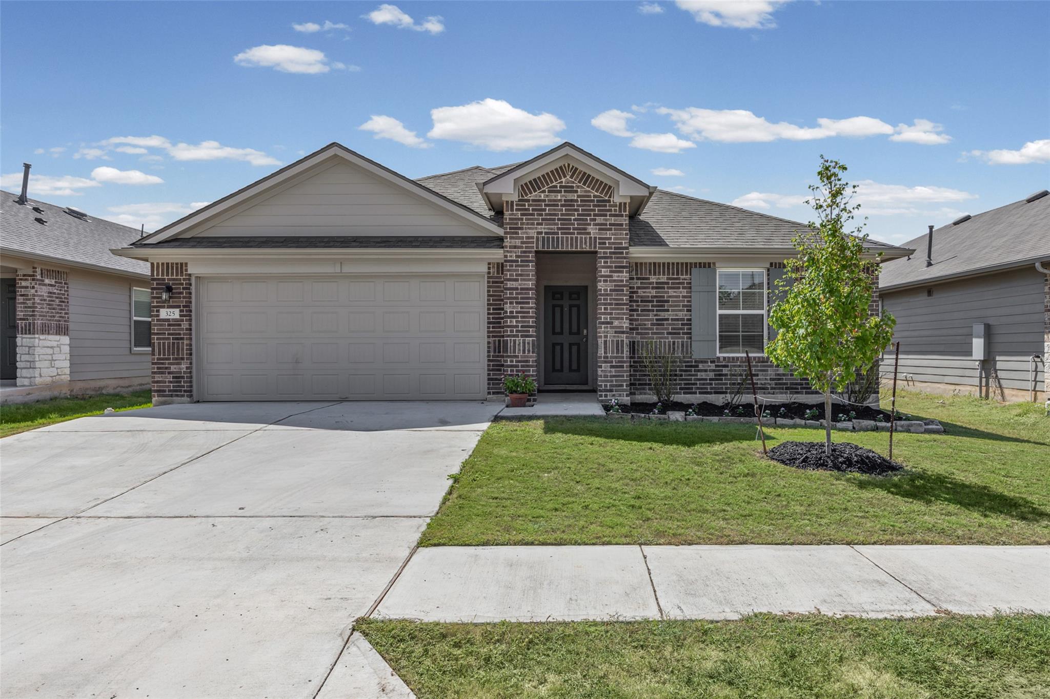 Brick detailing and classic gables frame a welcom