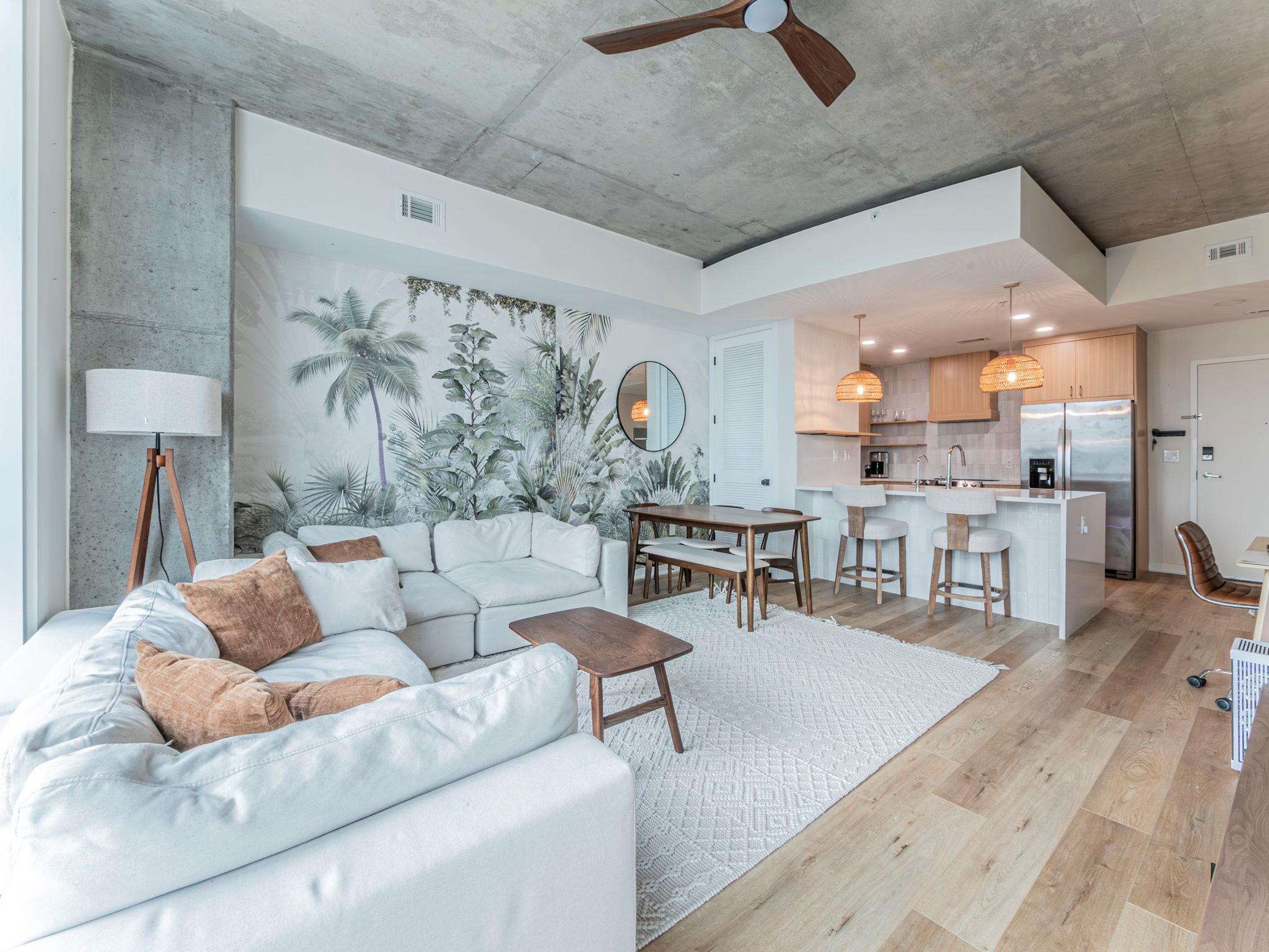 Exposed concrete ceilings and rich wood floors an