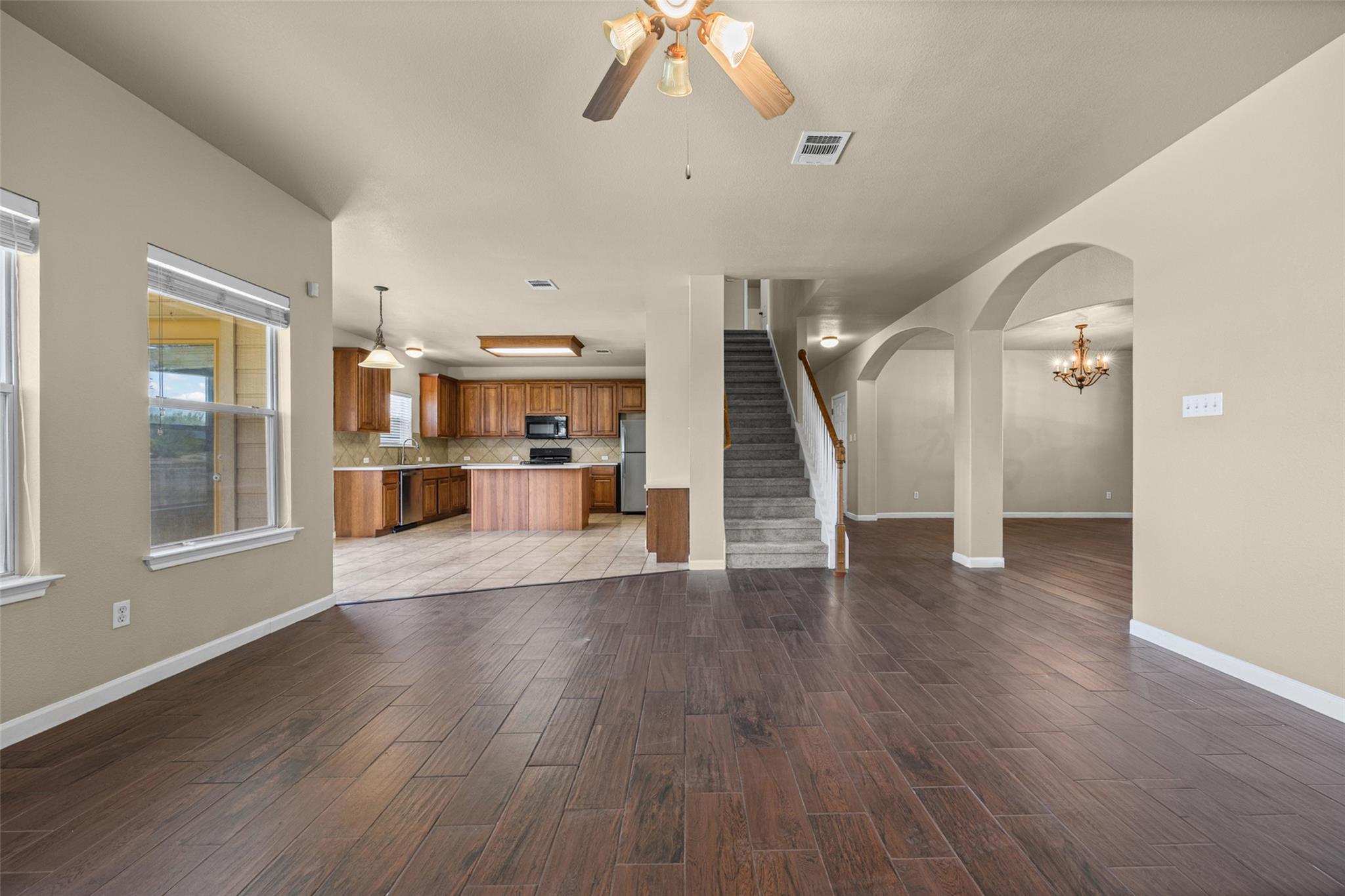 Rich wood-look flooring stretches across an open 
