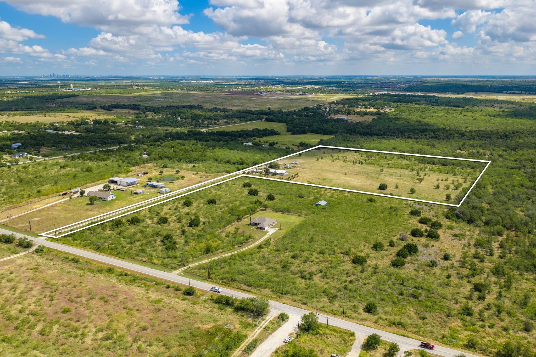 A wide aerial view captures the vast acreage bord