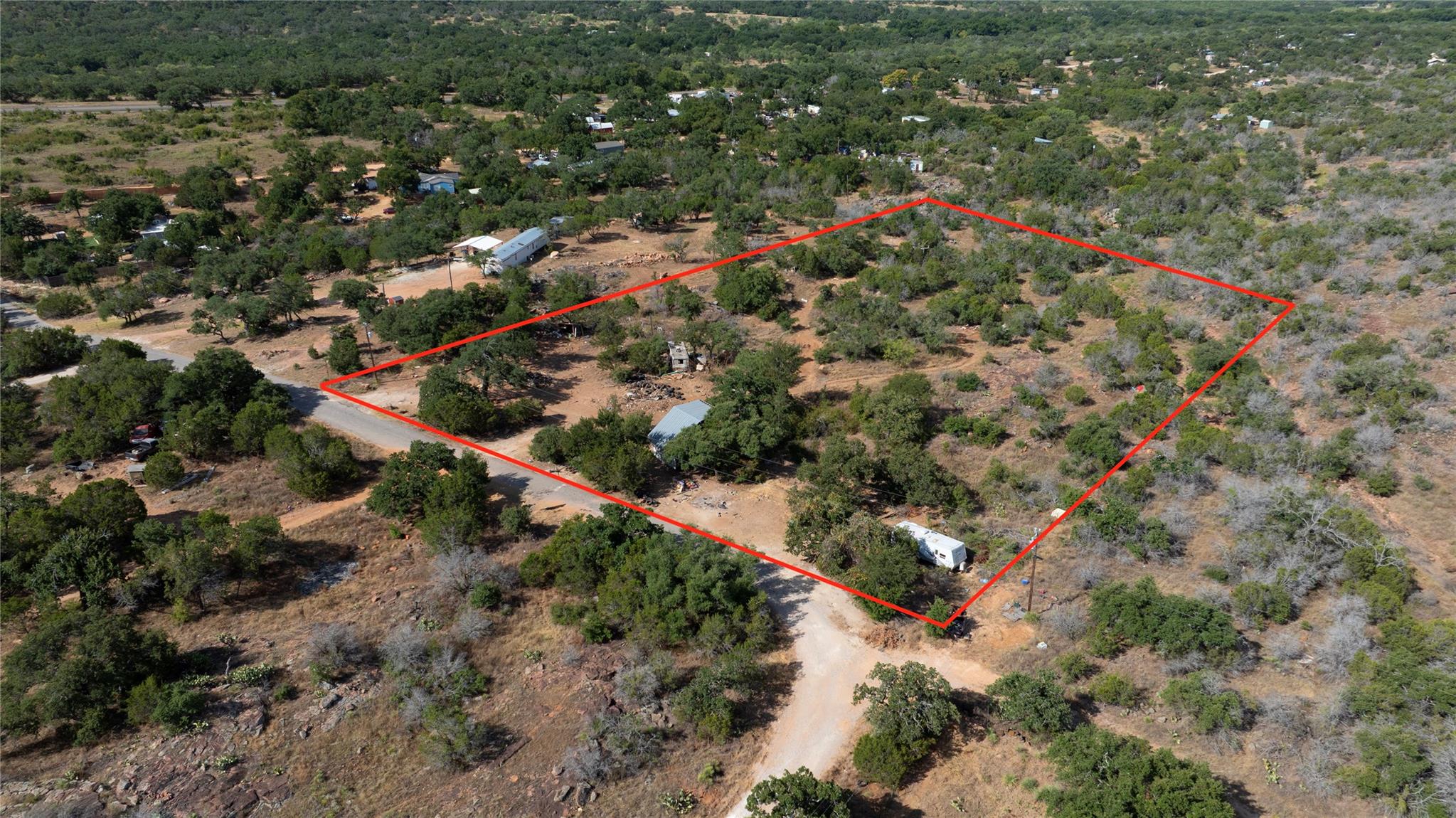 Mature trees and native vegetation cover this exp