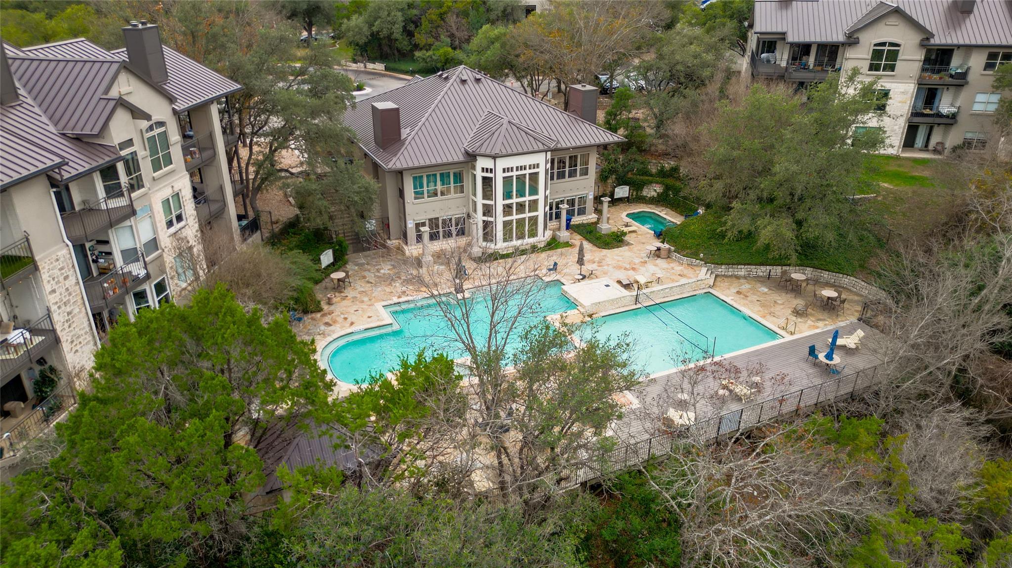 Aerial view captures a sprawling stone patio surr