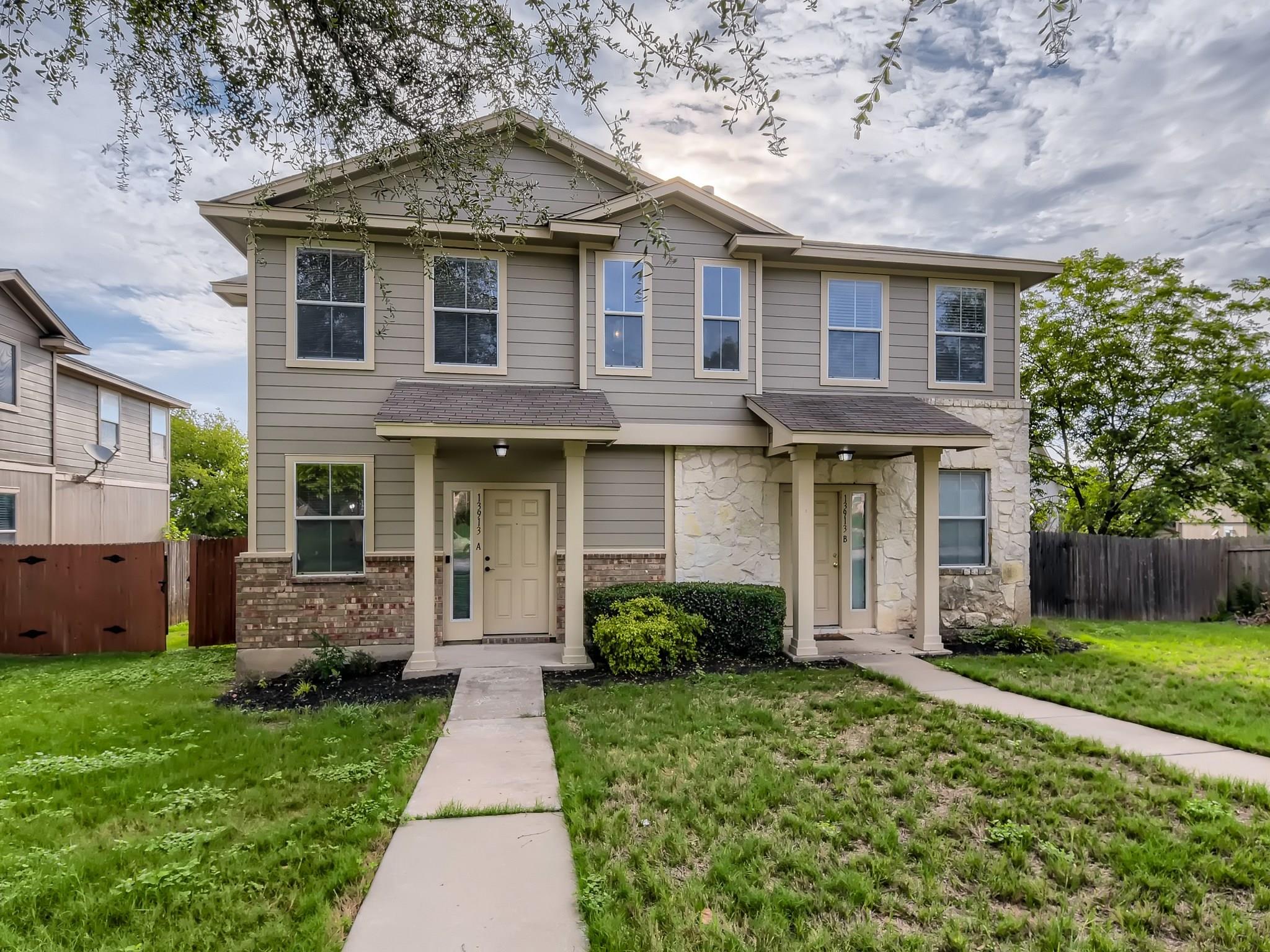 Symmetry and classic siding accent this multi-fam