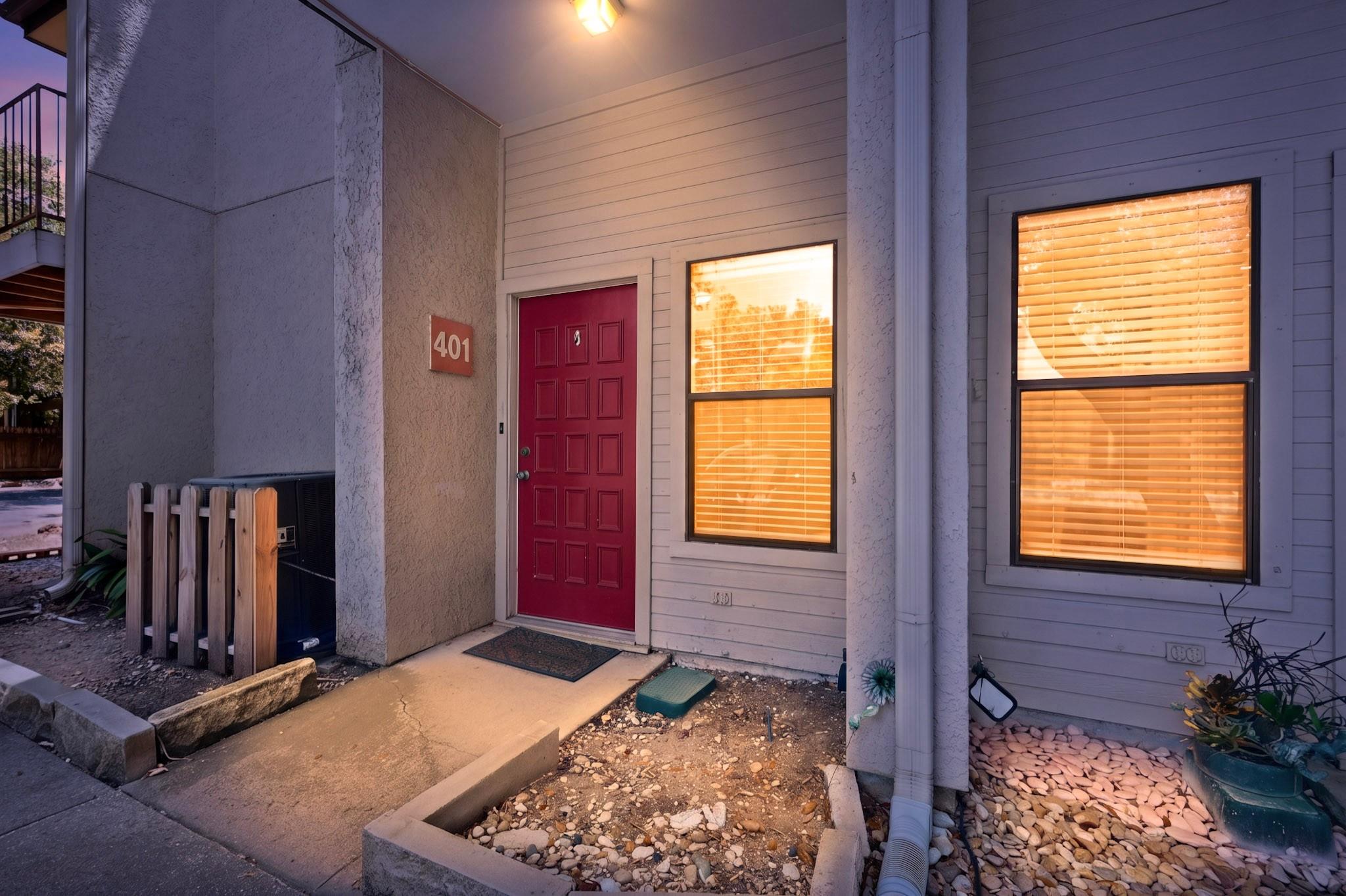 A welcoming front entrance features a concrete wa